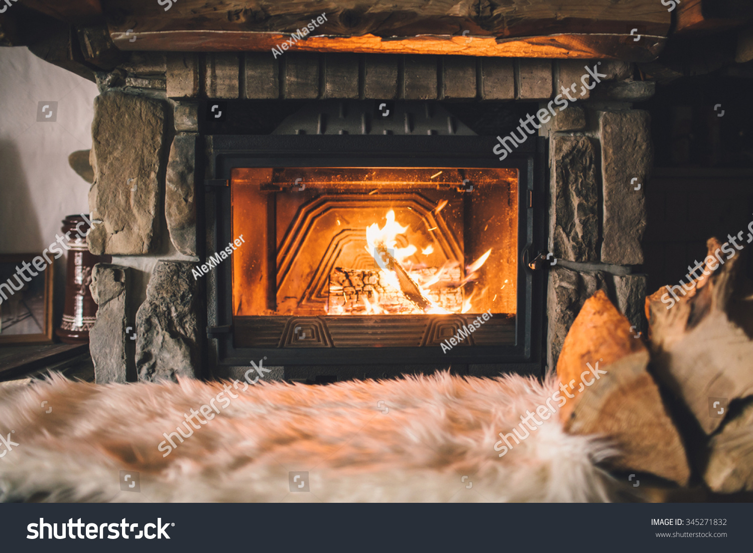 Warm cozy fireplace with real wood burning in it. Cozy winter concept. Christmas and travel background with space for your text.