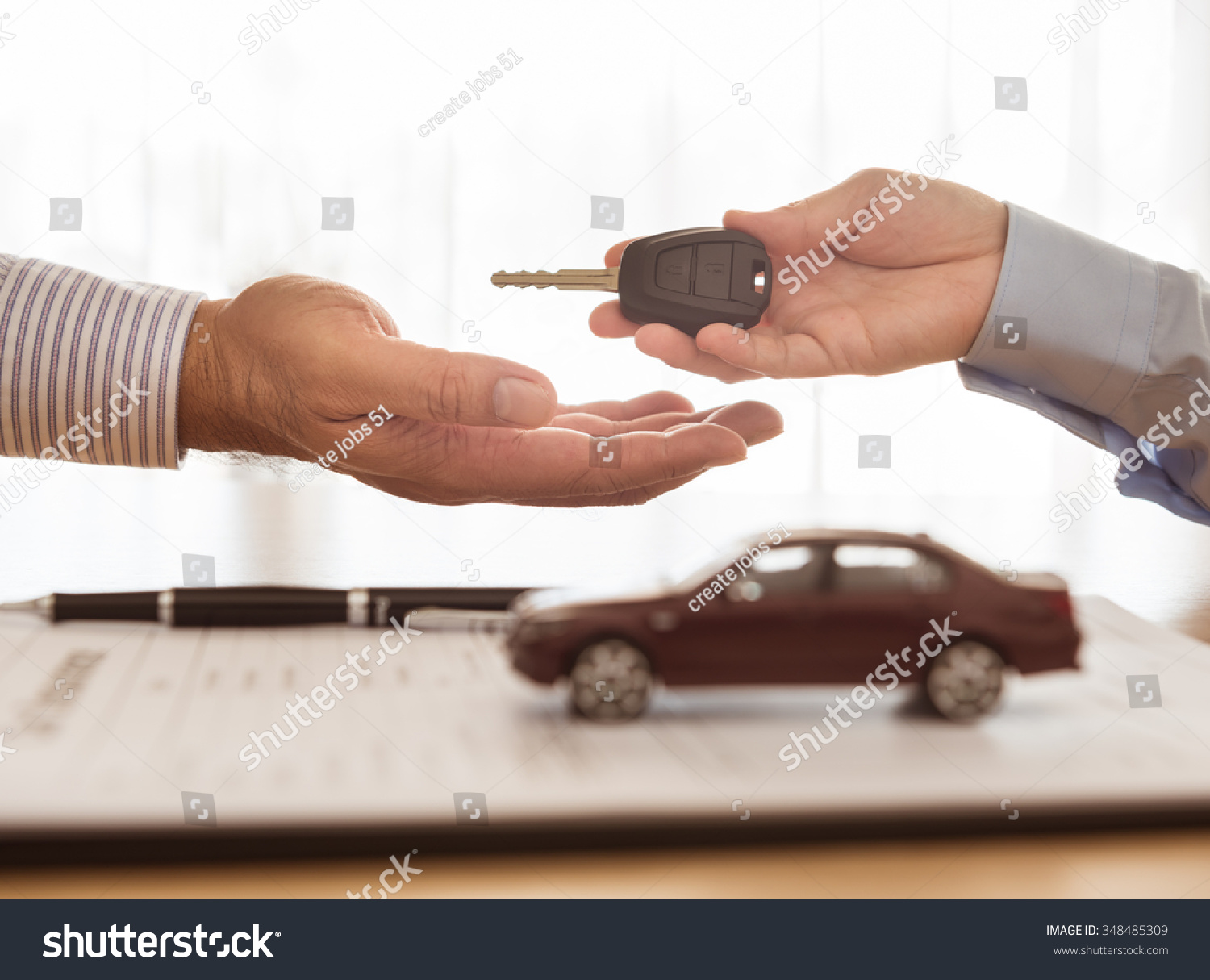 Salesman sends the car keys to the client. Concept of car insurance  rental  sales.
