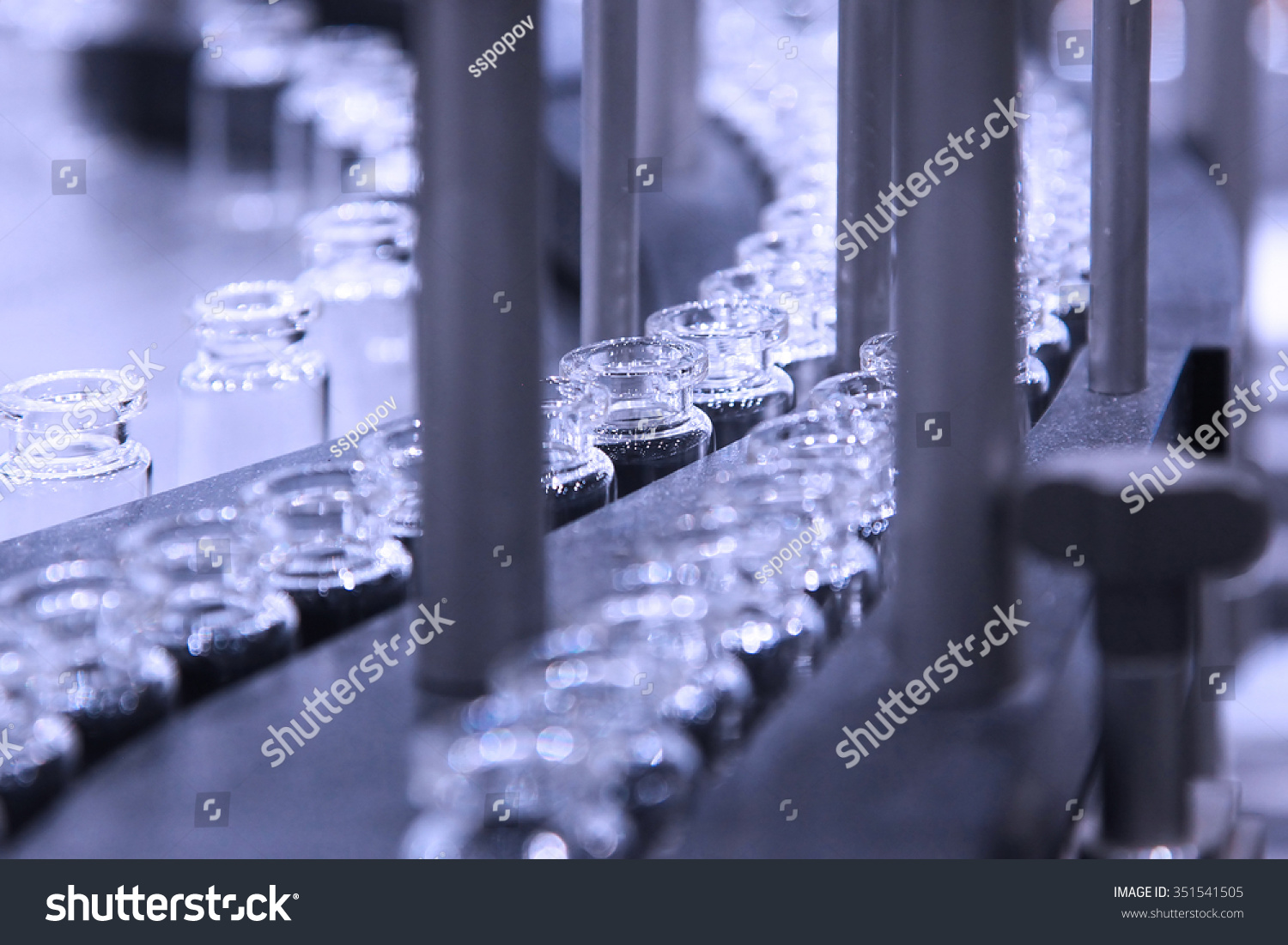 pharmaceutical industry. Line machine conveyer for packaging glass bottles ampoules in boxes at pharmacy factory