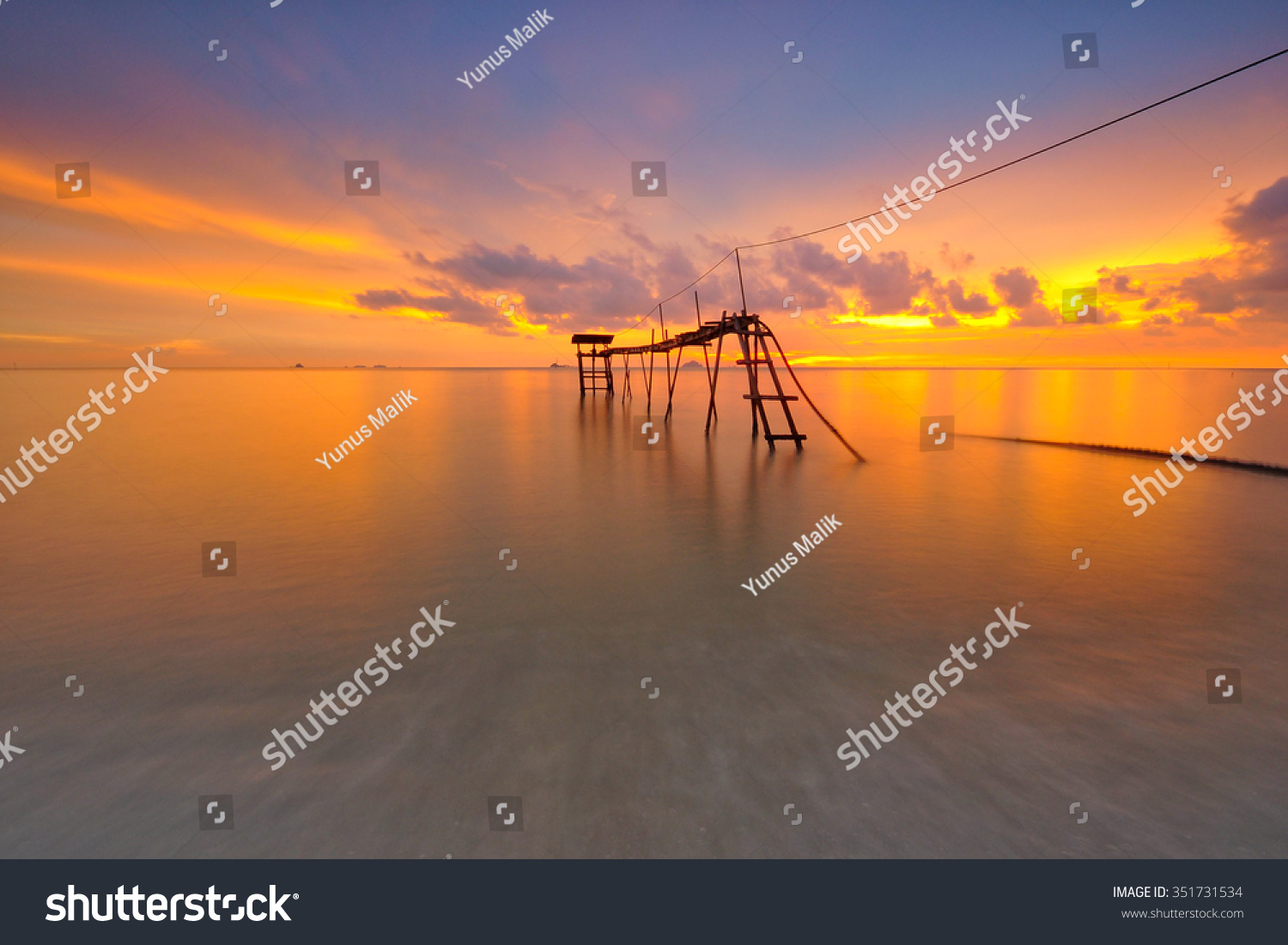 Beautiful long exposure shot of fishermen jetty at dusk. Soft focus due to long exposure shot. Vibrant colors. Composition of nature.