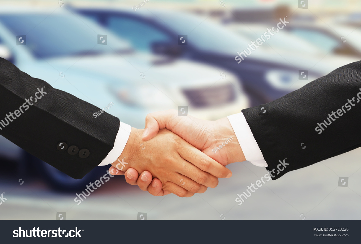 business man shake hand with rental car background