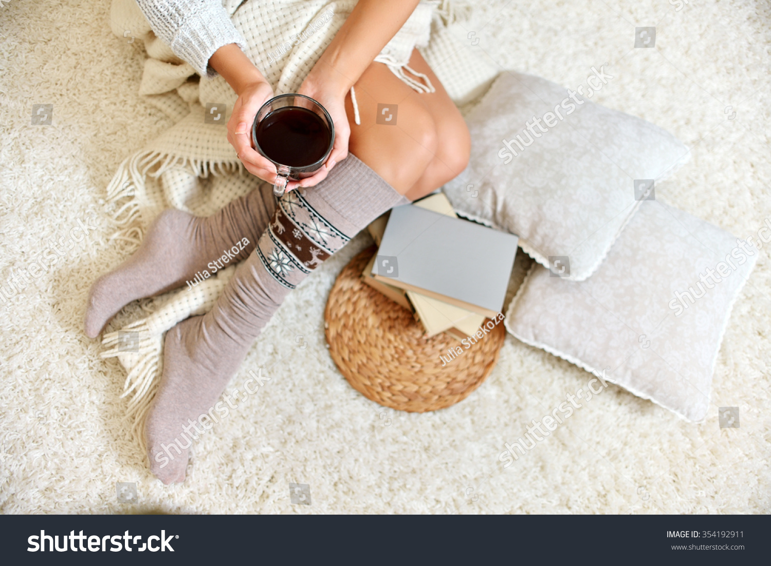 Young beautiful woman in warm knitted handmade clothes at home. Model fashion shooting. Autumn winter season. Gaiters. Golfs. Leggings.