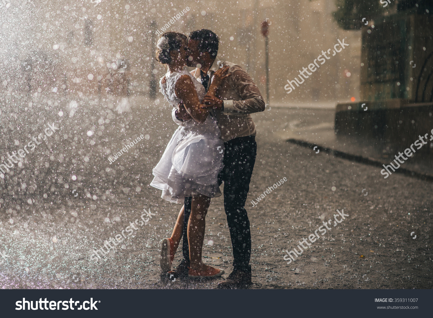 wedding couple dancing in the rain