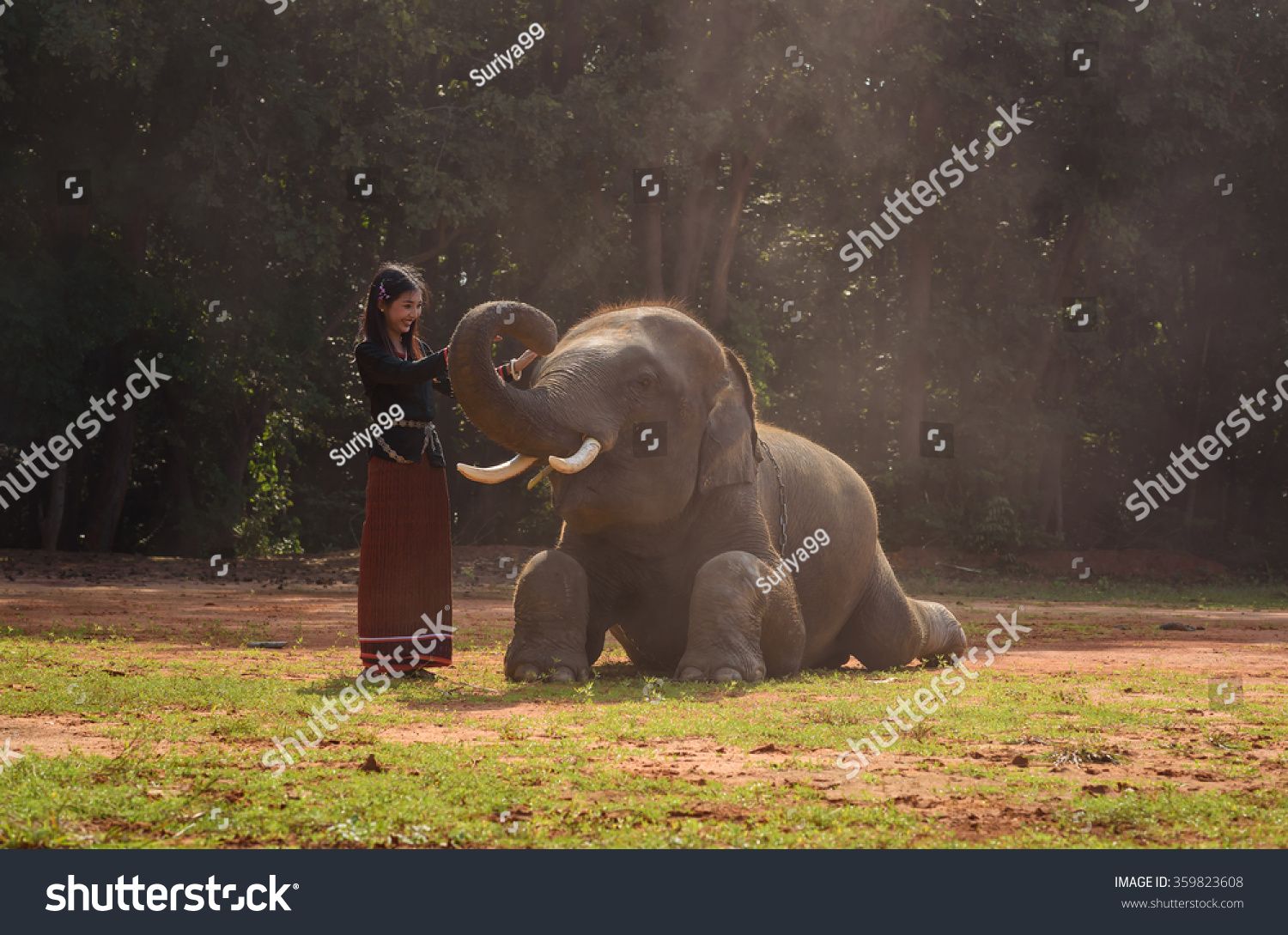 Woman in asian tradition dress at elephant village of lays light in Thailand.