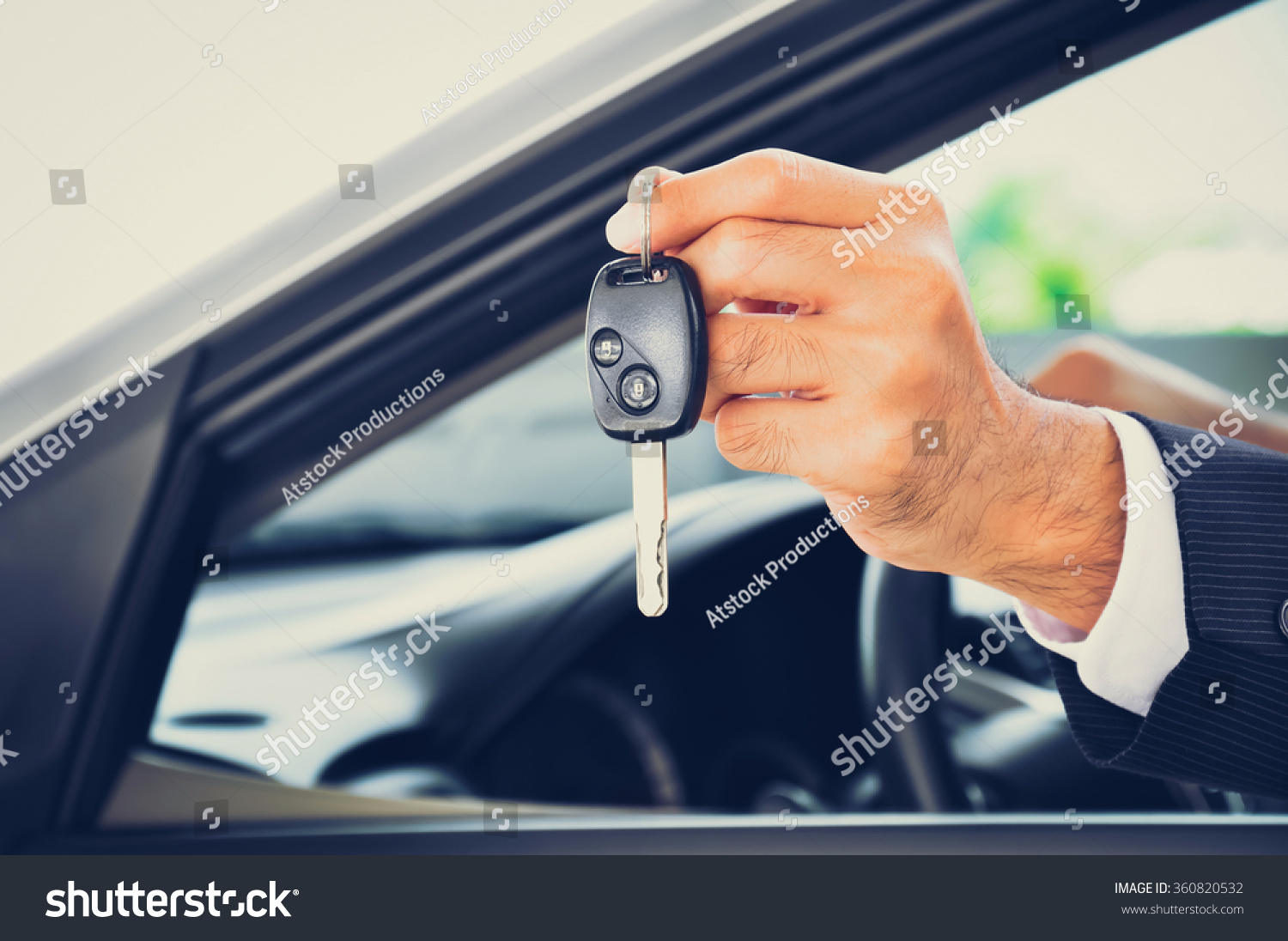 Hand holding a car key - car sale & rental business concept  vintage tone
