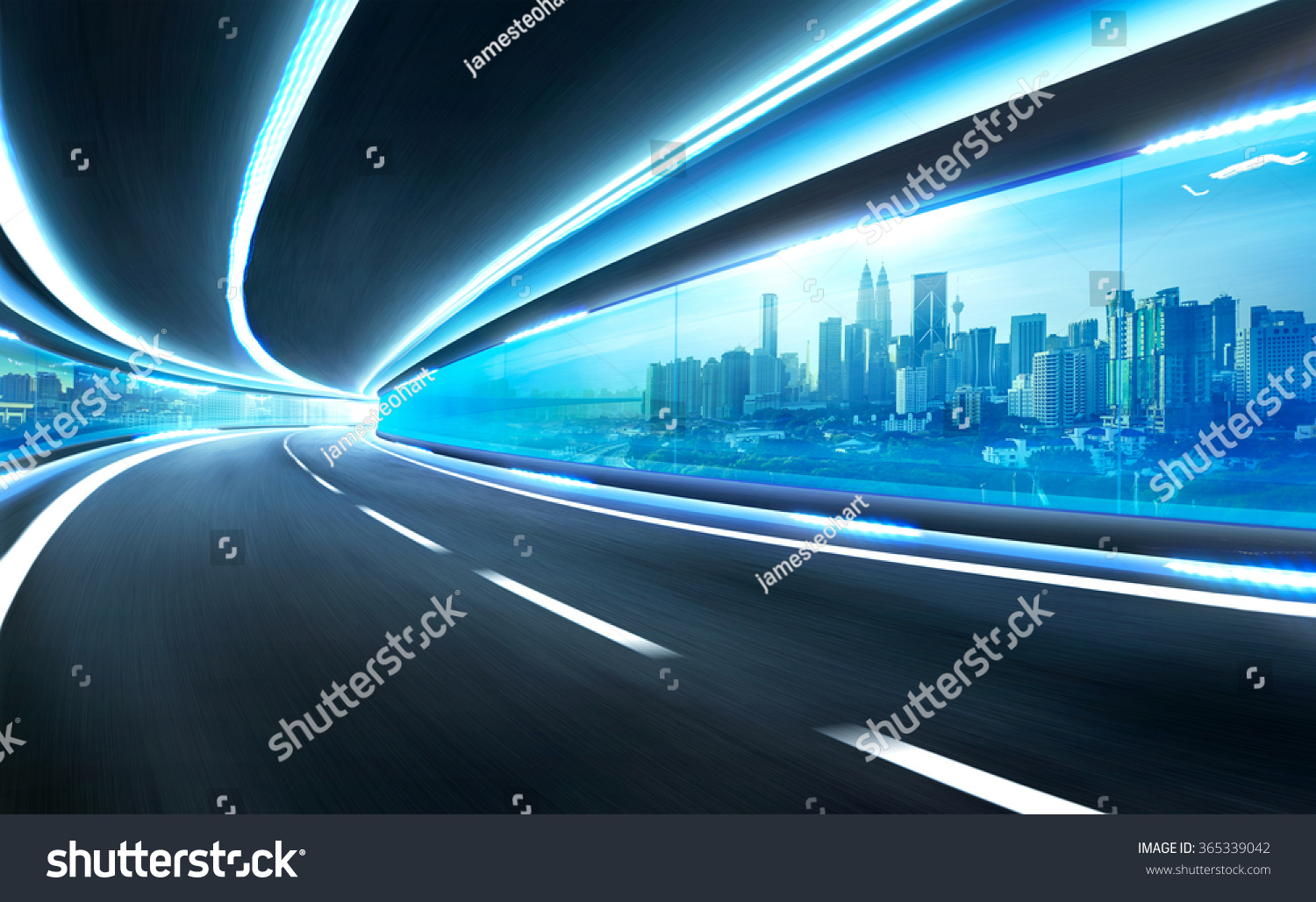 Abstract blurred speed motion road in glass tunnel over the city