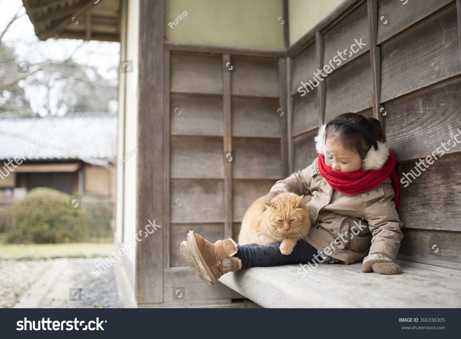 Girl playing with cat