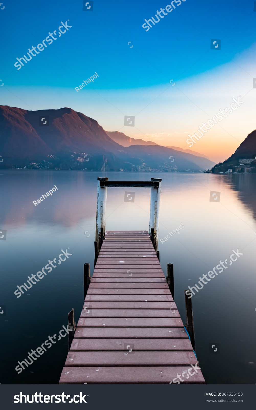 Sunset at Lake Lugano  Switzerland with wooden jetty as the foreground