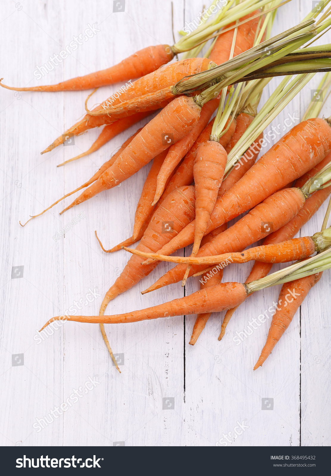 Dry organic carrots on wooden table