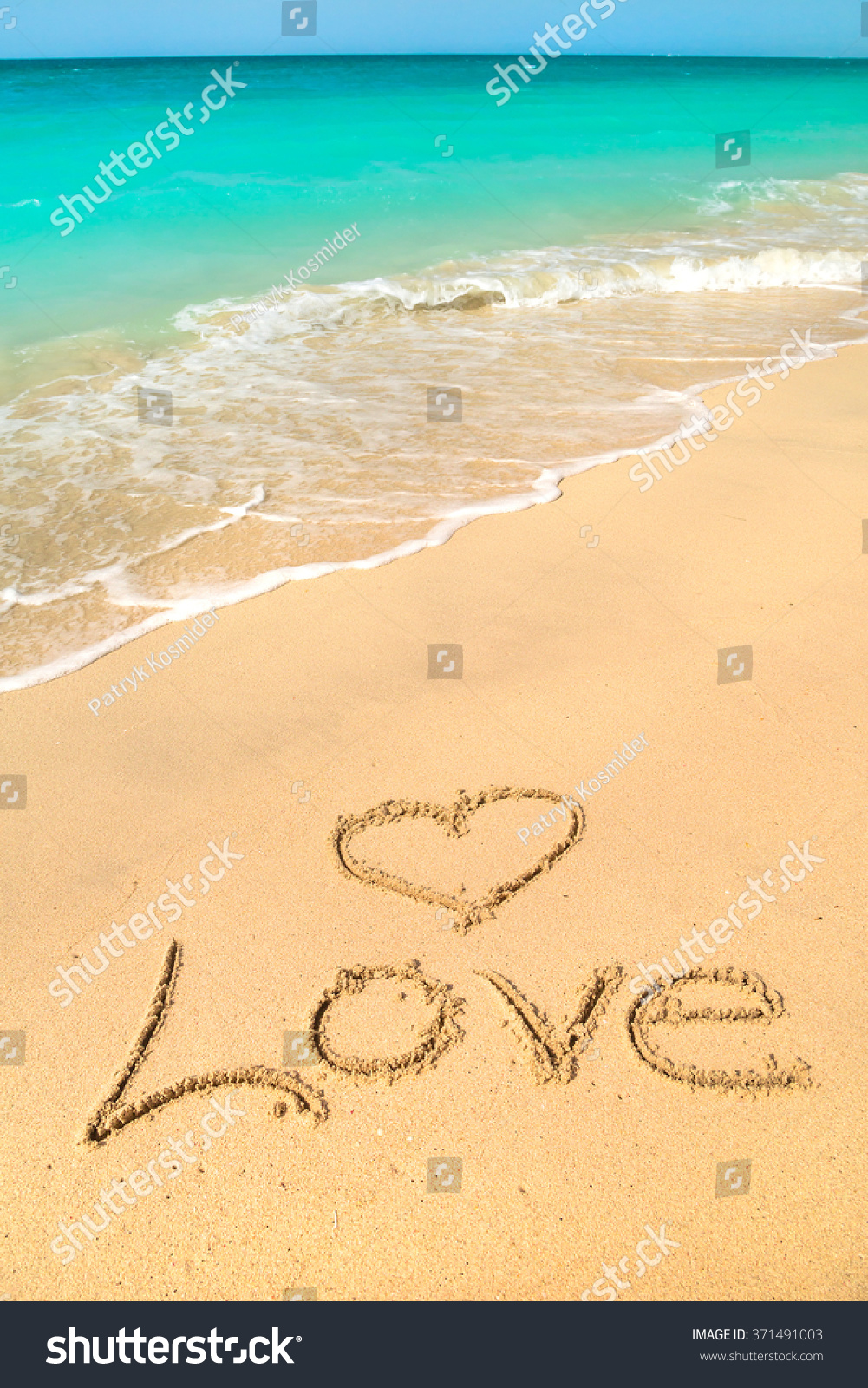 Love sign on the beach with turquoise water