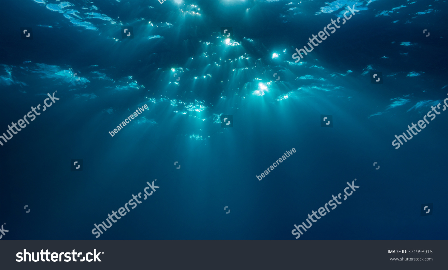 Beams of light dapple the Ocean surface underwater. Malapascua  Philippines  November.