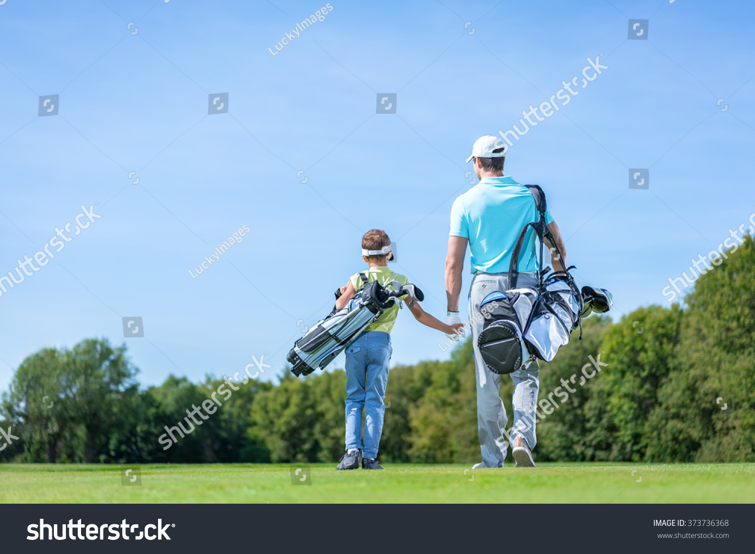 Father and son on golf course