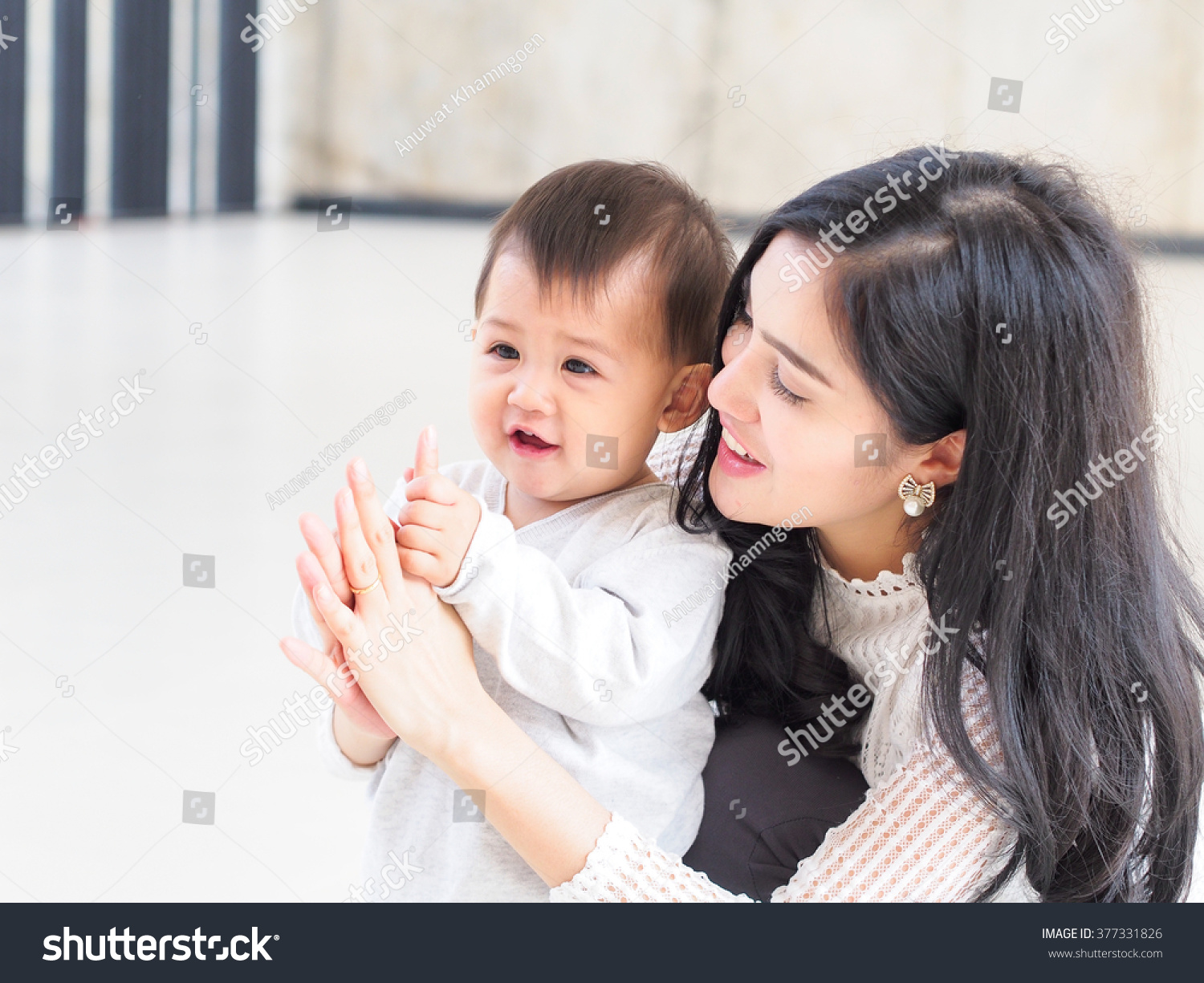 Beautiful Asian mother and son on indoor daylight.