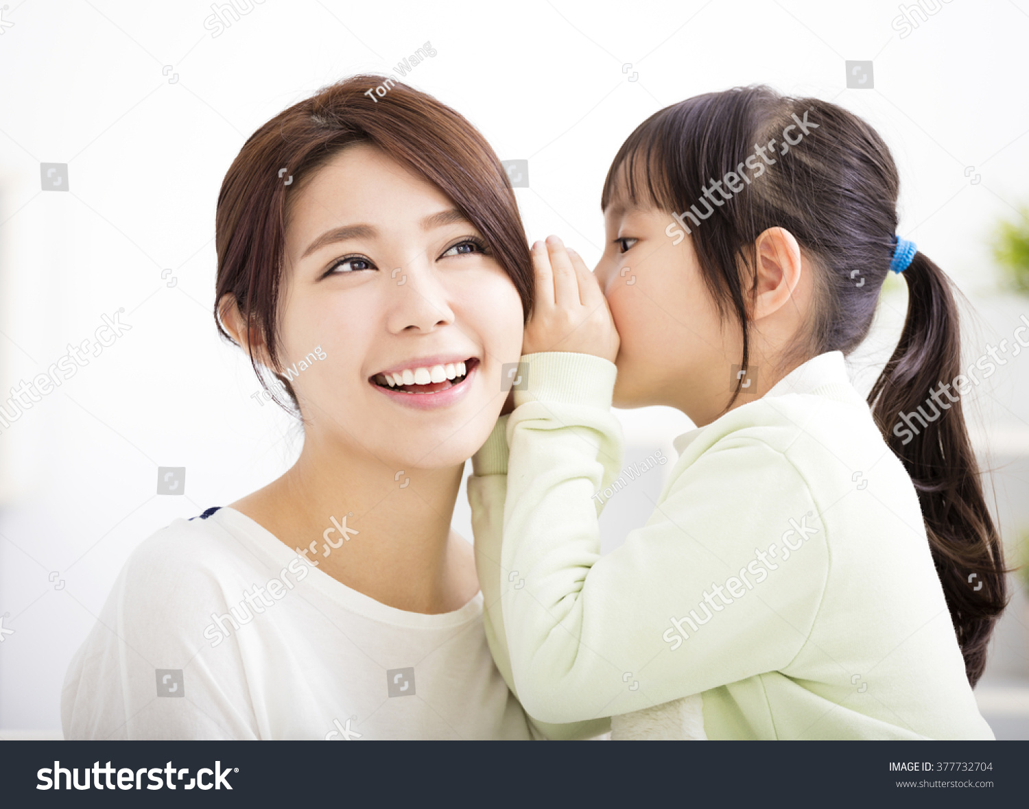 mother and daughter whispering gossip