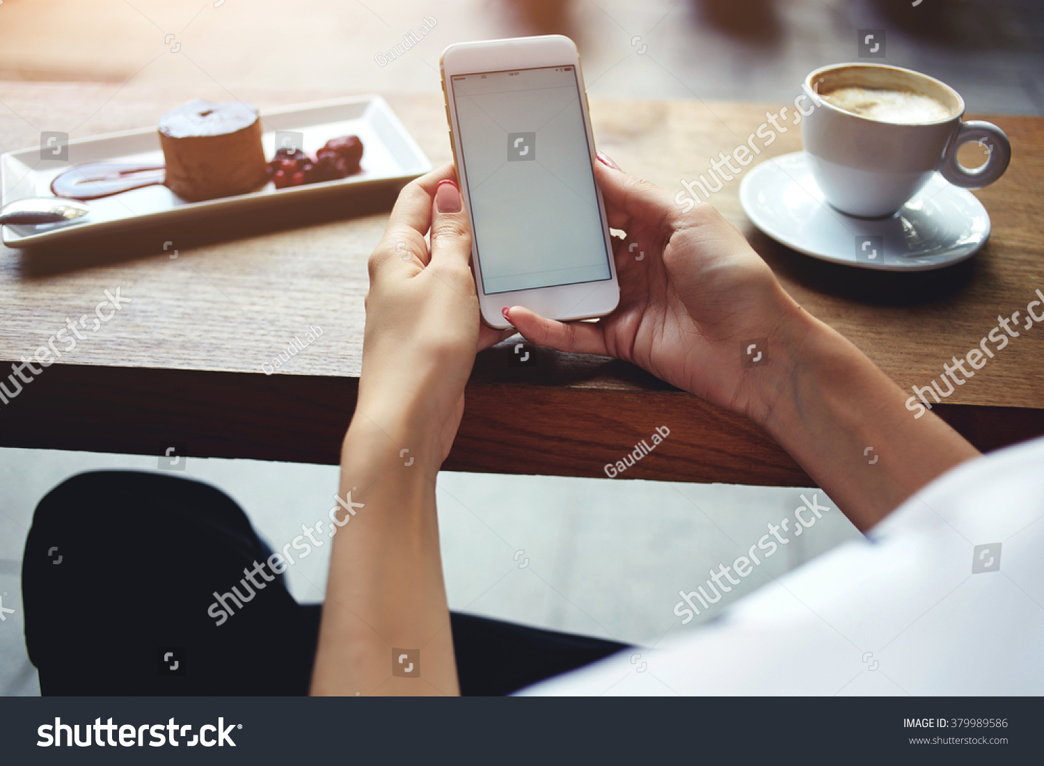 在咖啡店里休息期间 在咖啡店休息期间 女性的手握住手机的女性手握住手机 用空白复制空间屏幕 女性阅读新闻
