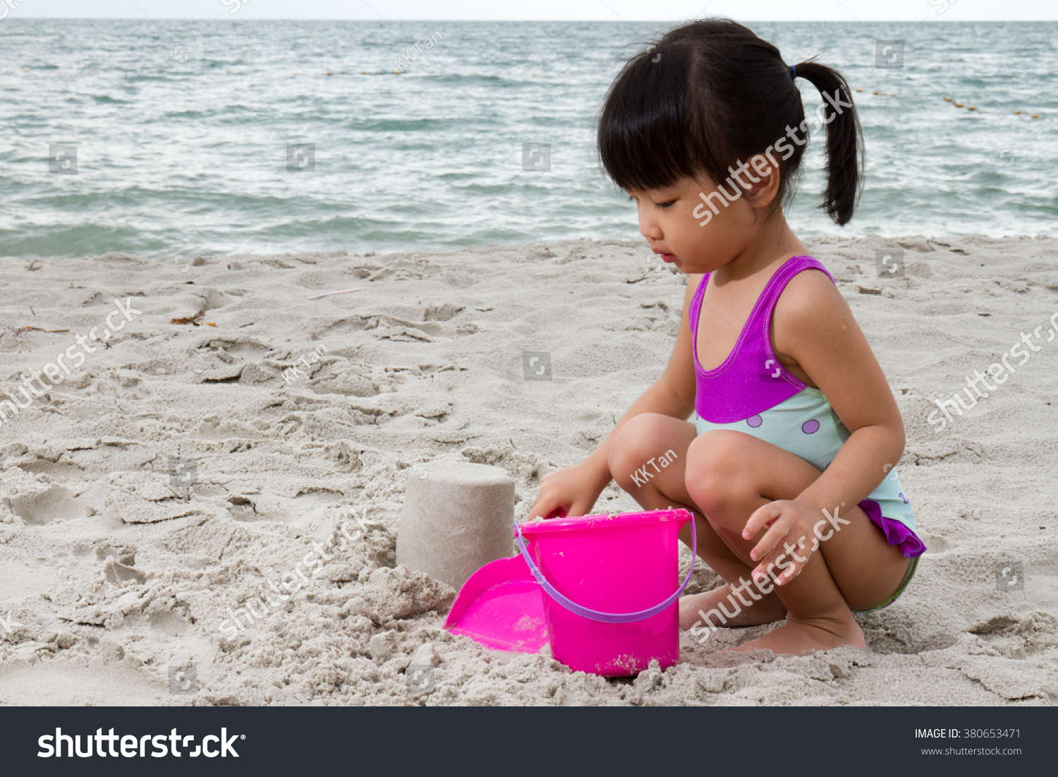 Asian Little Chinese Girl Playing Sand with Beach Toys on Tropical Beach