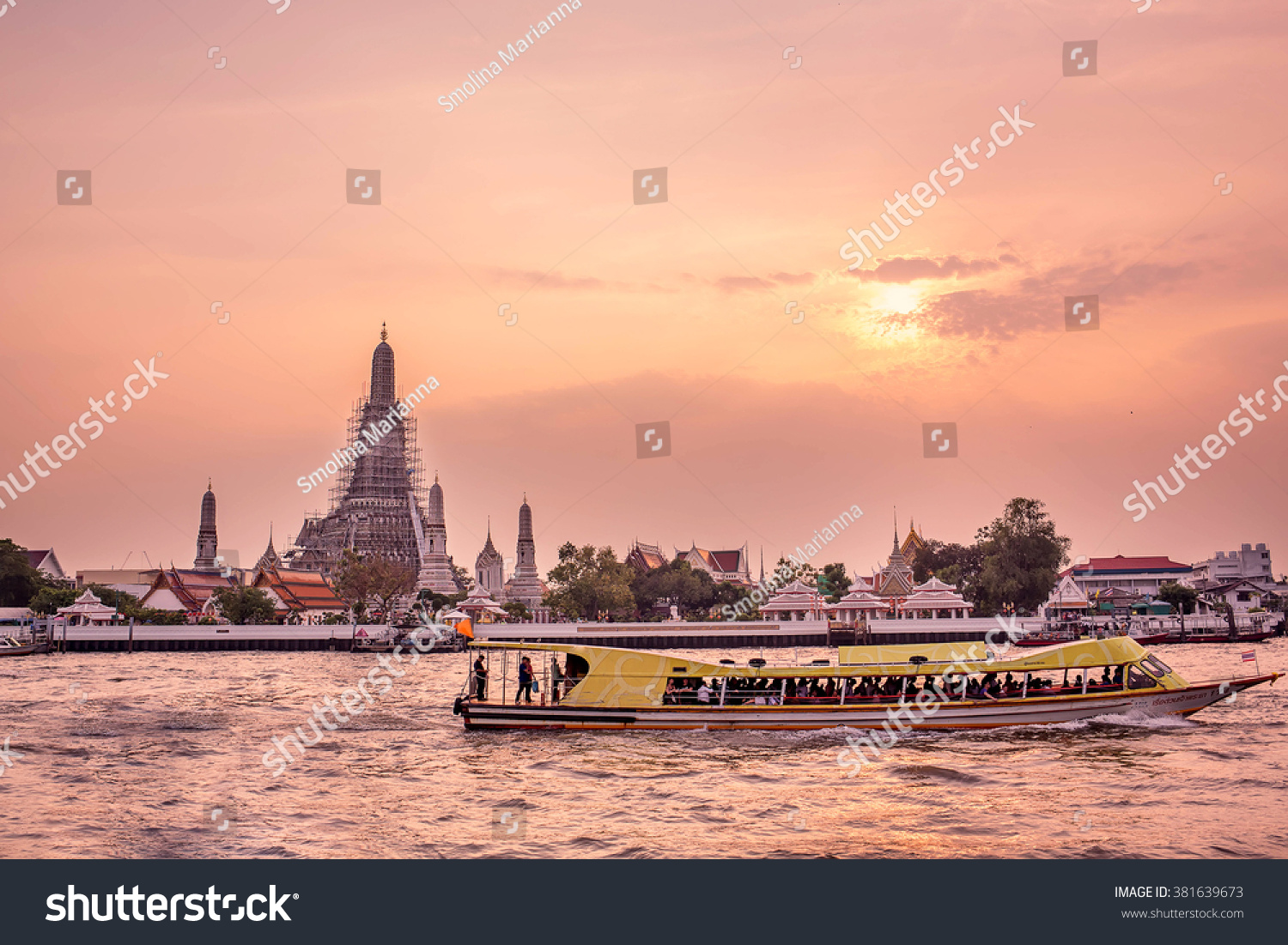 Wat Arun (Temple of dawn) standing on the Chao Phraya river at sunset in Bangkok Thailand. Image with selective focus and toning