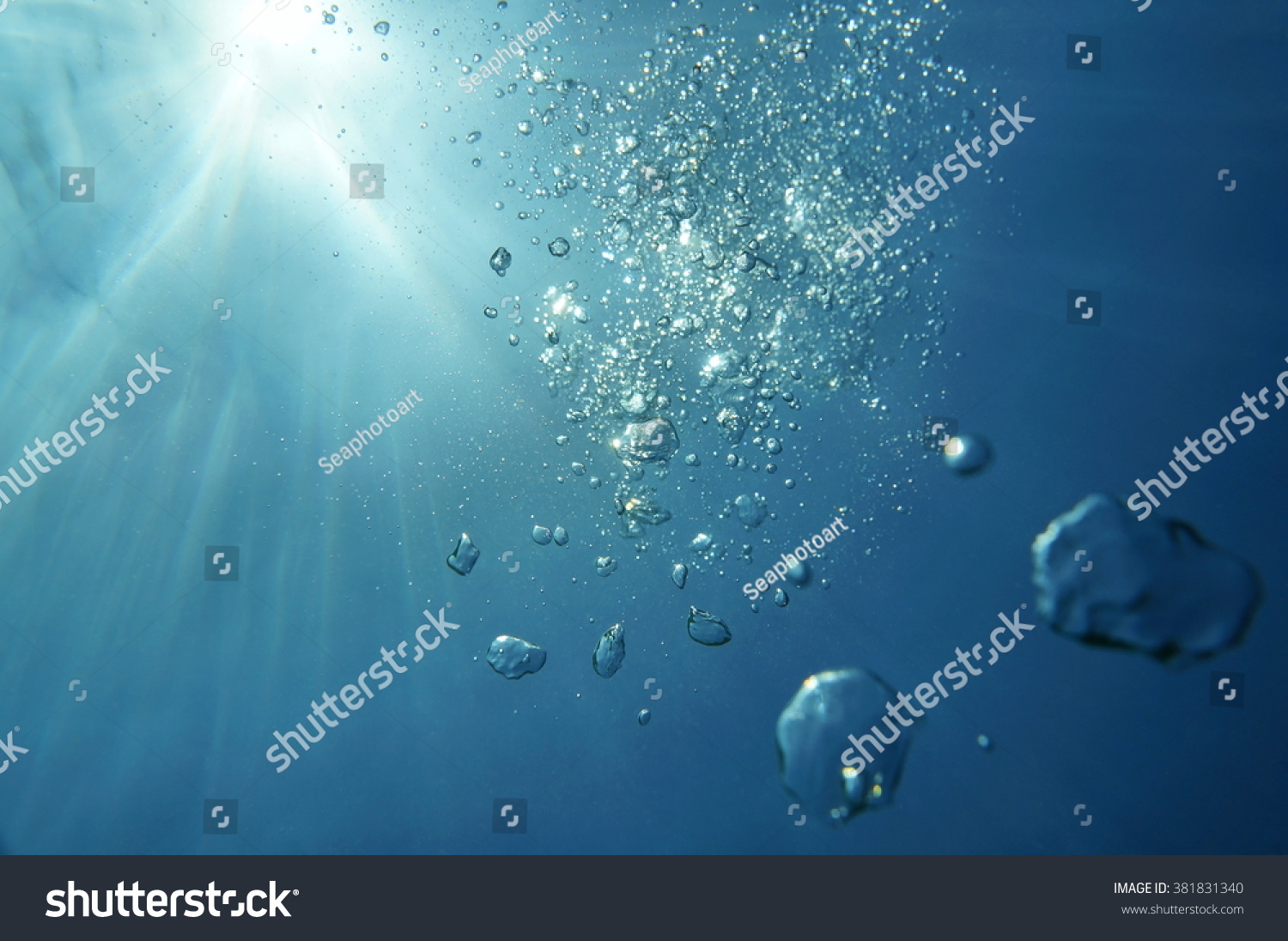 Underwater bubbles with sunlight through water surface  natural scene  Caribbean sea