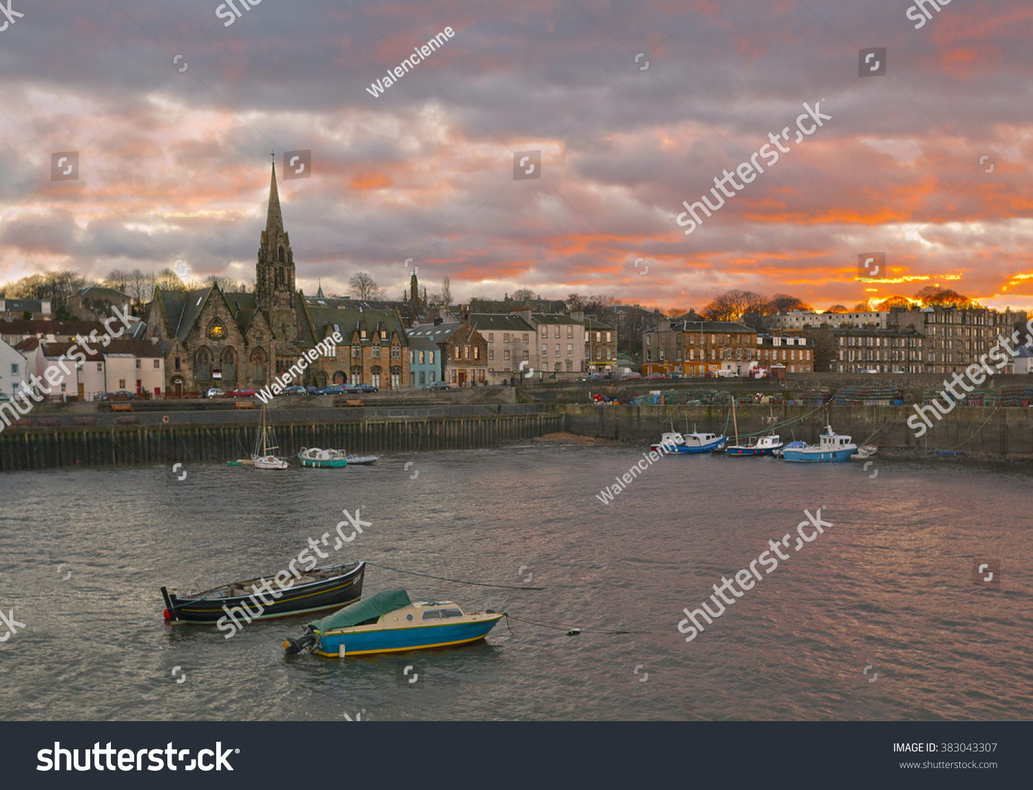 View of Leith area of Edinburgh Scotland in the winter with red sunset and boats on the foreground