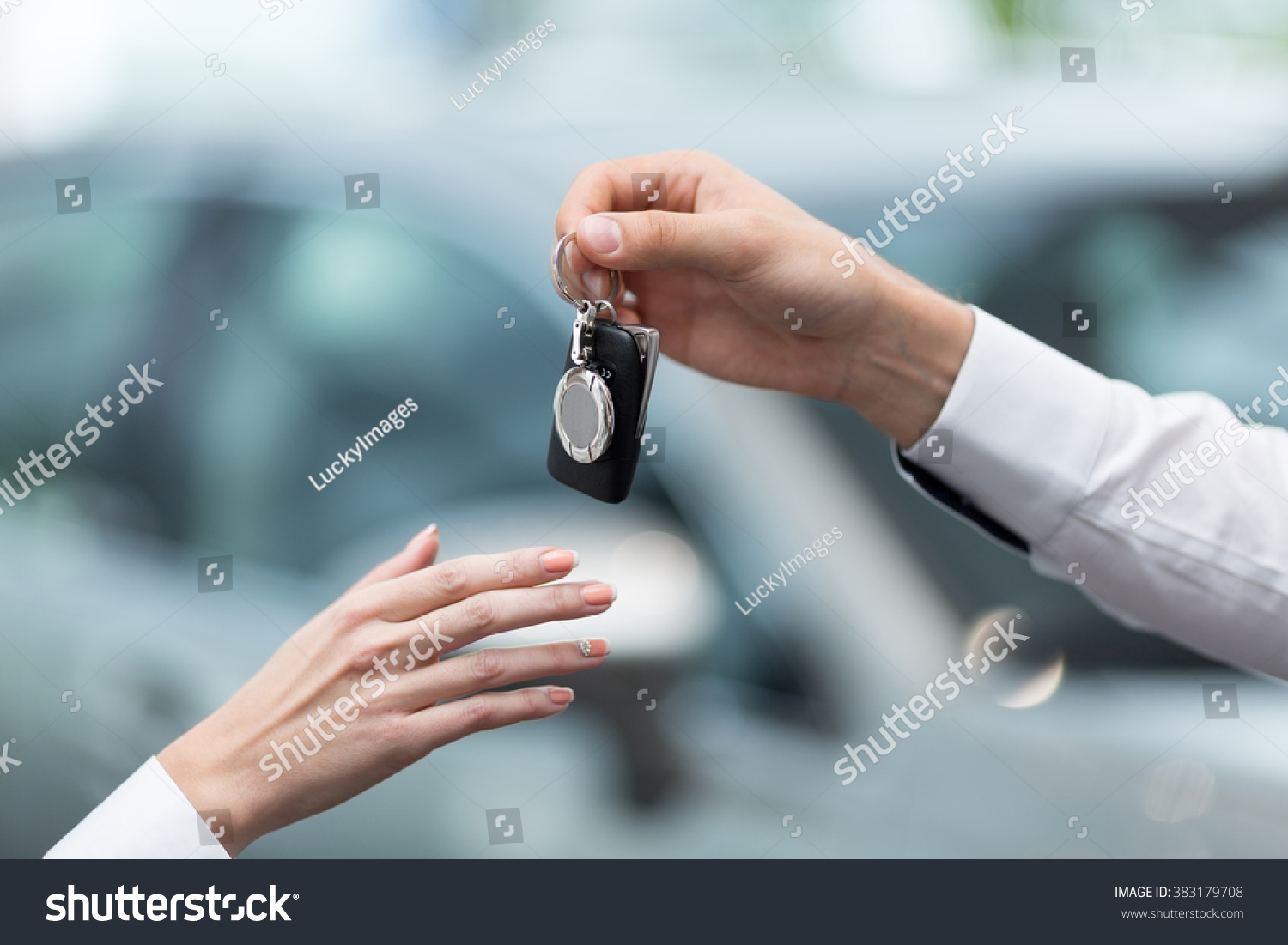 Hand with car keys indoors