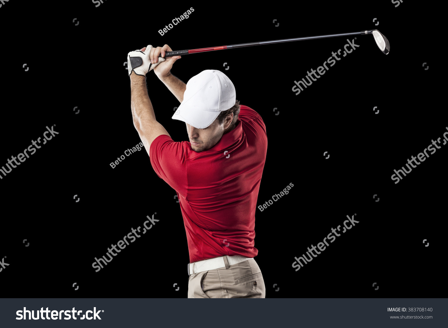 Golf Player in a red shirt taking a swing  on a black Background.