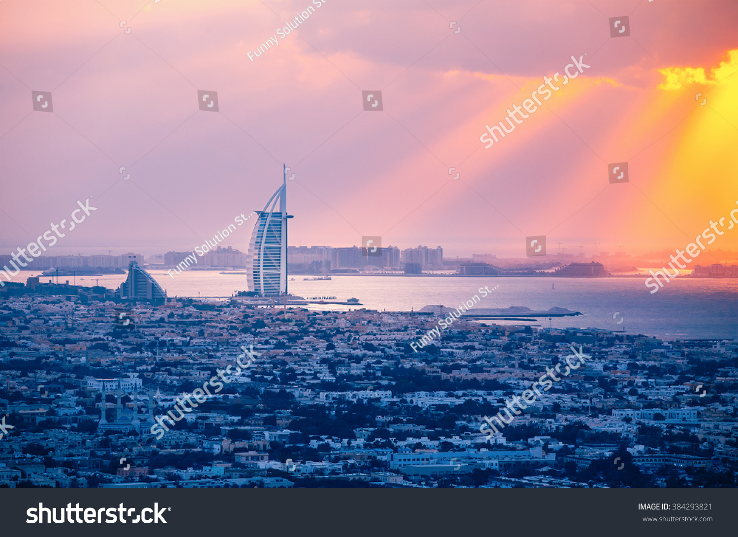 Rooftop view of Dubai at sunset with the seaside. 