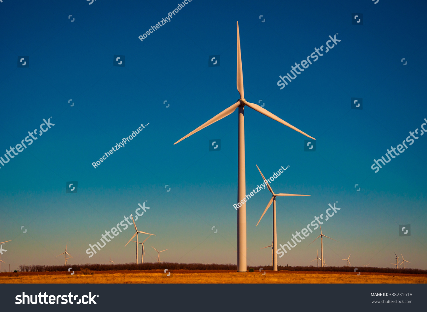 Wind Energy Blows into Future Amarillo and West Texas Wind Turbine Farms in the lone star state at colorful sunset with all colors of the rainbow showing renewable energy works