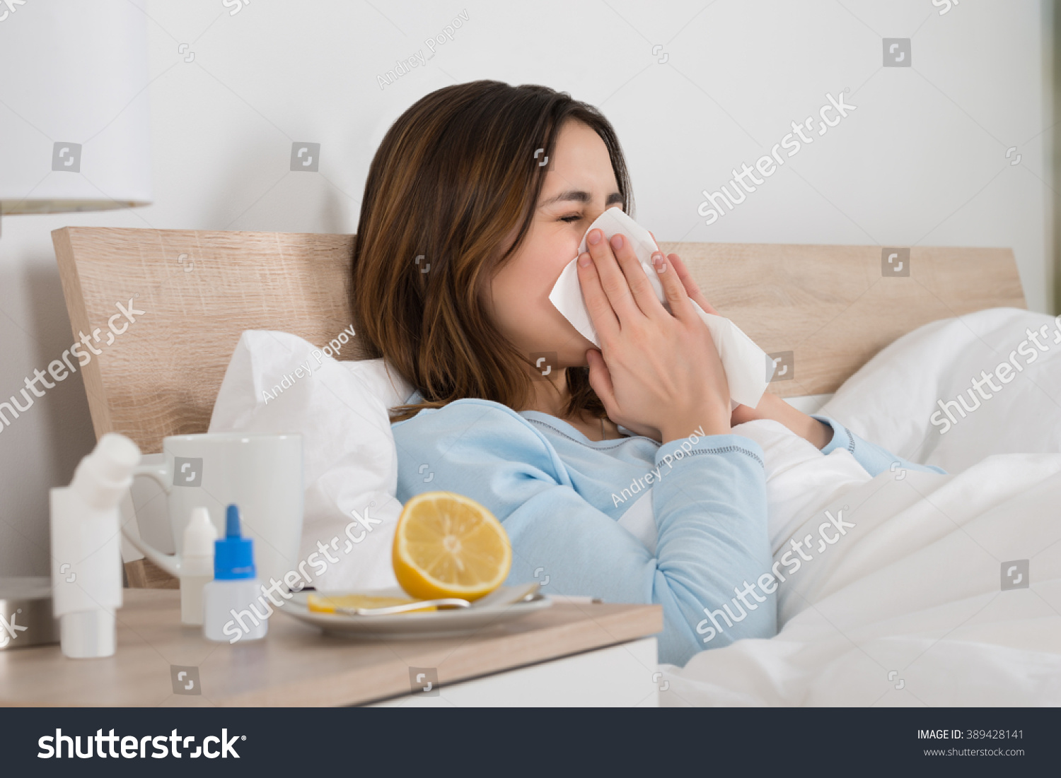 Young Woman Infected With Cold Blowing Her Nose In Handkerchief