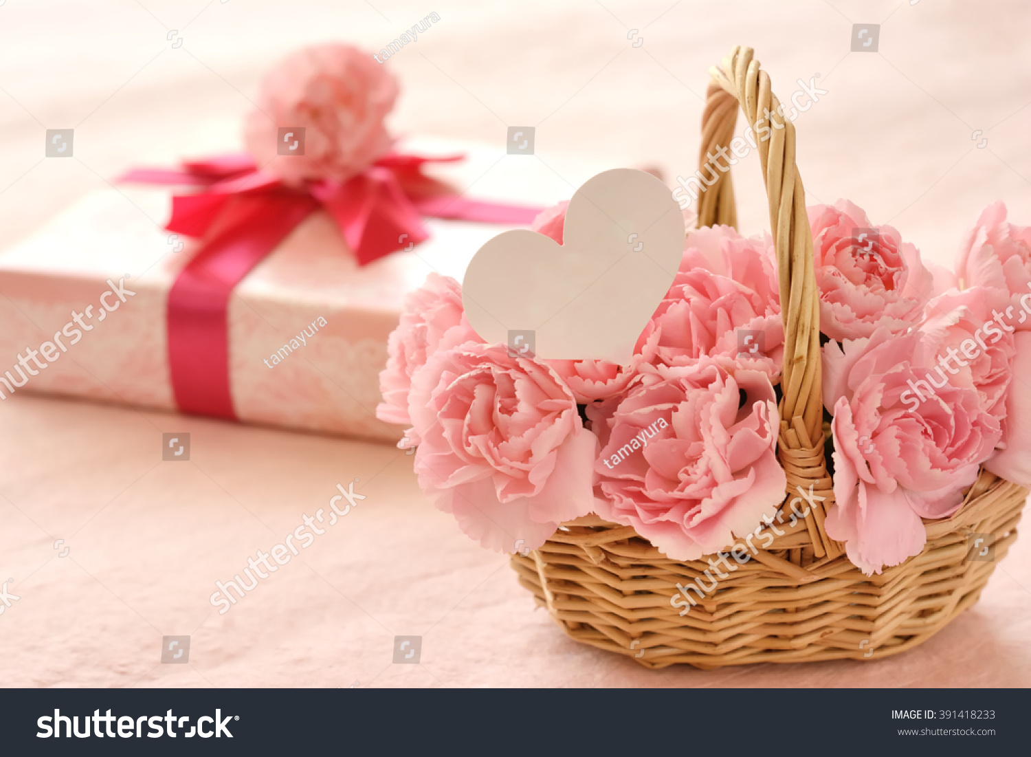 pink carnation and gift box with white heart paper
