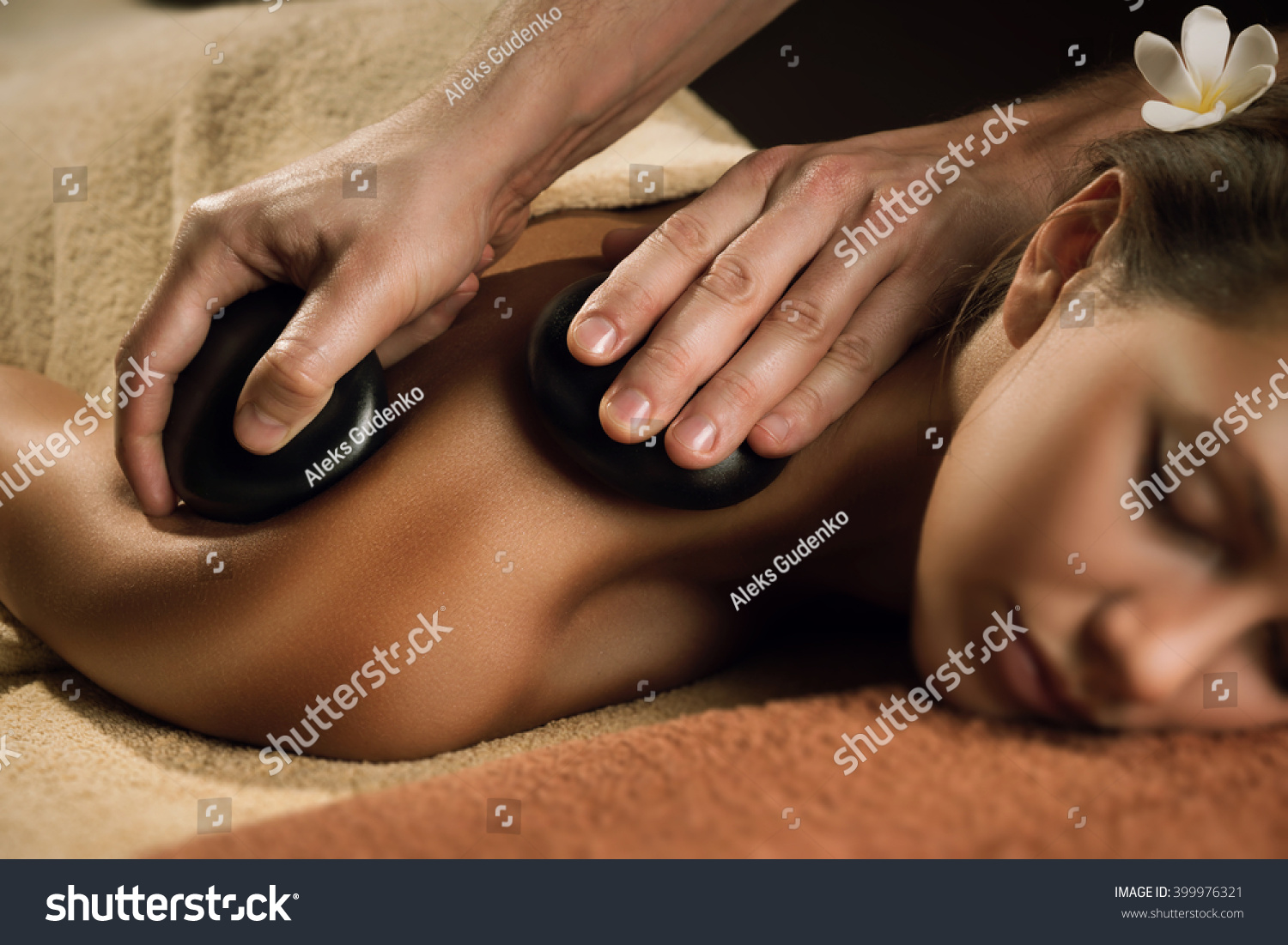 Massage with hot basalt stones. Beautiful deep charming light.