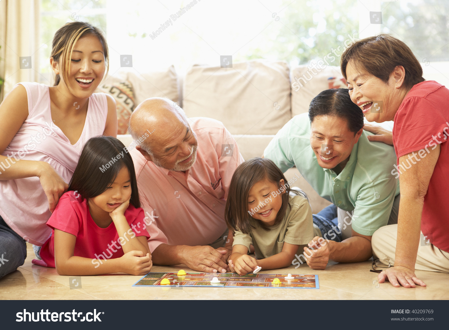 Extended Family Group Playing Board Game At Home