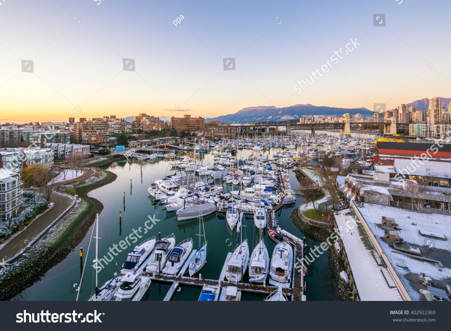 Snowy view from the Granville Bridge onto the Granville Island. Downtown skyline in Vancouver Canada.