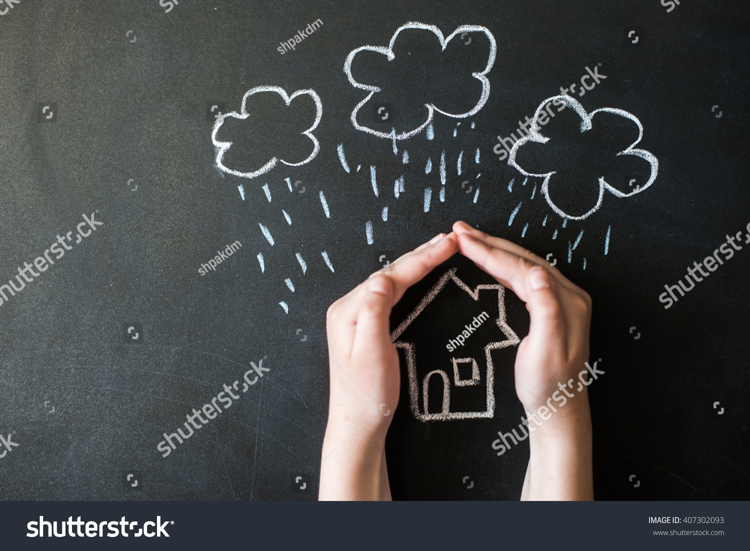 hands protects a house from the elements - rain or storm