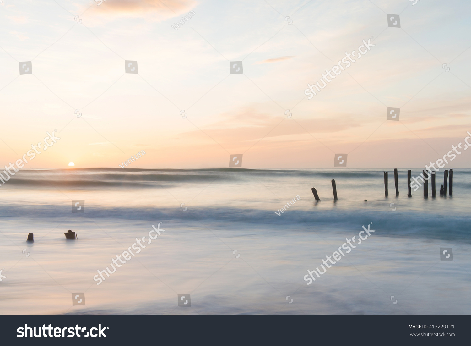 old jetty piles at St. Clair Beach in Dunedin at dawn  New Zealand