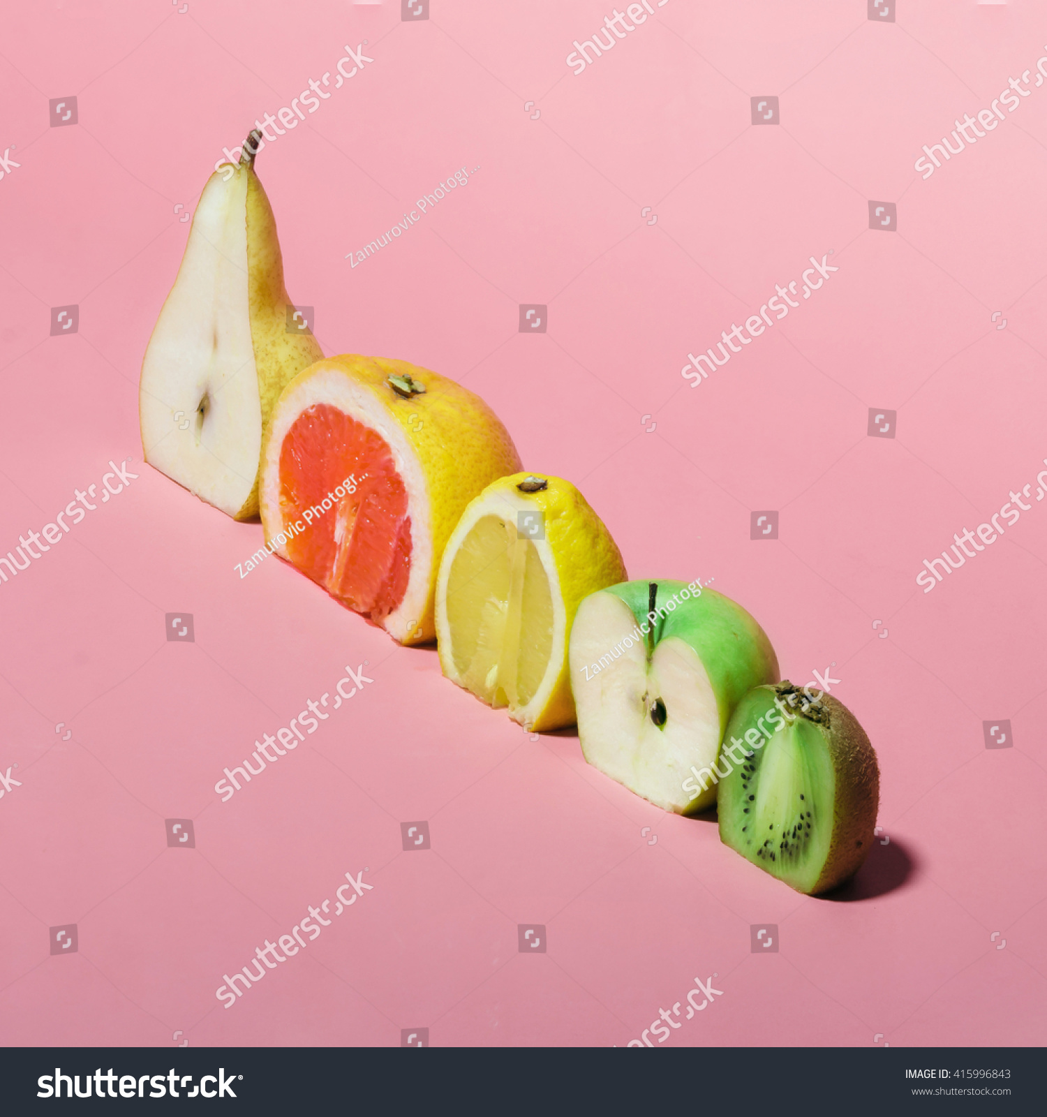 Various fruits sliced in half. Minimal concpet.