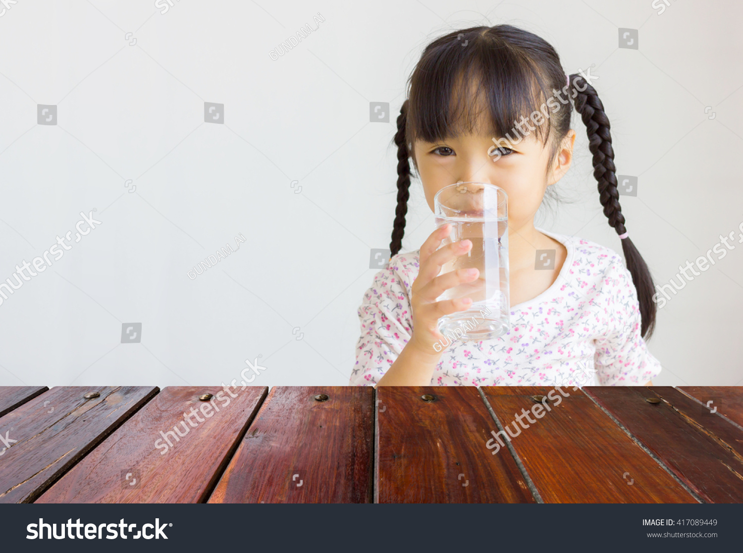 Look out from the table  asian girl drink water as background.