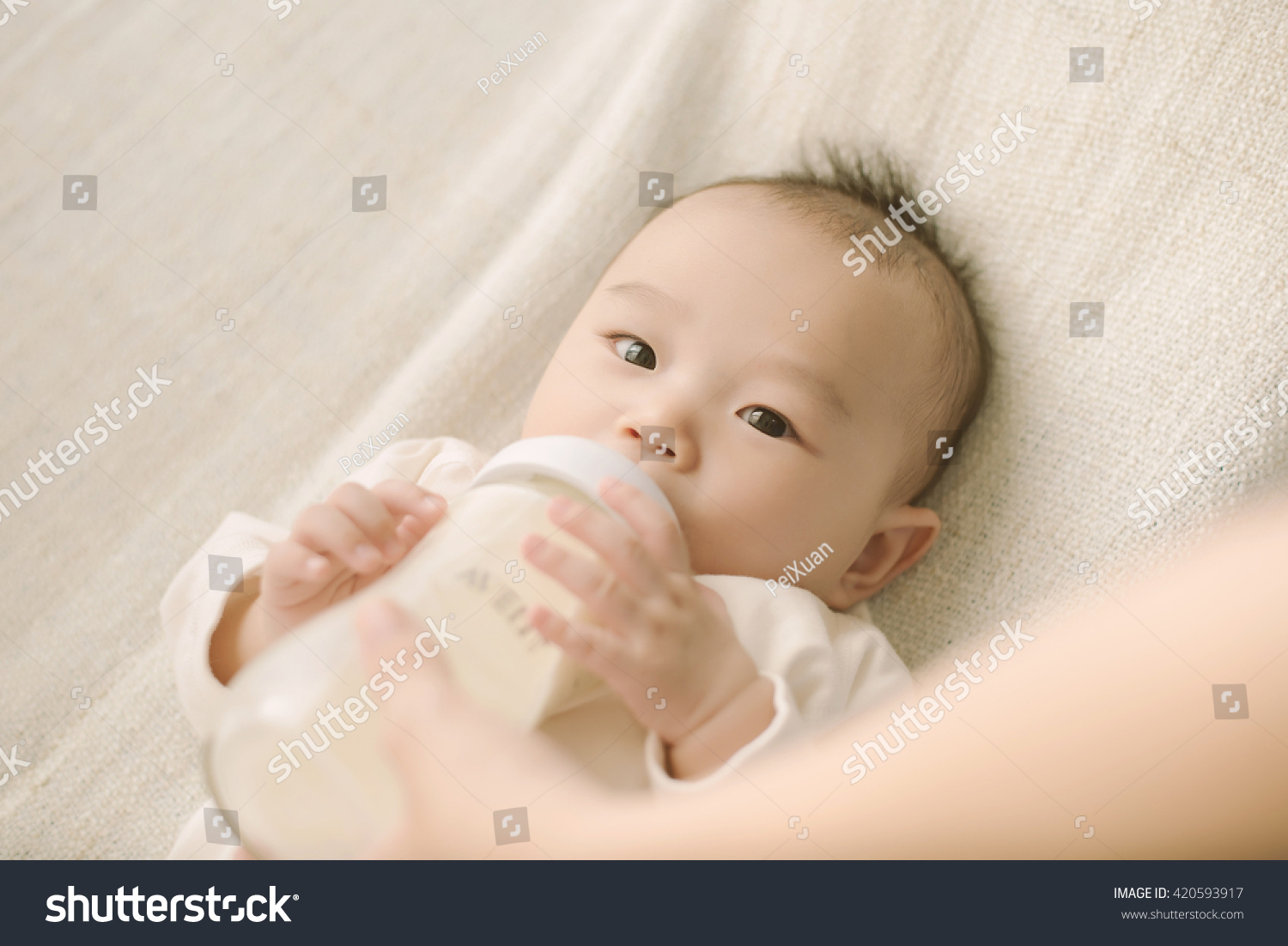 newborn baby sucking bottle