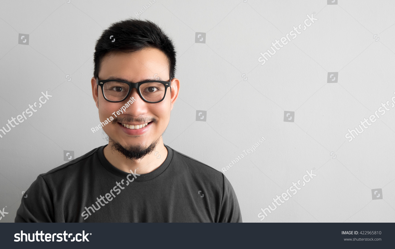 Happy Asian man with eyeglasses.