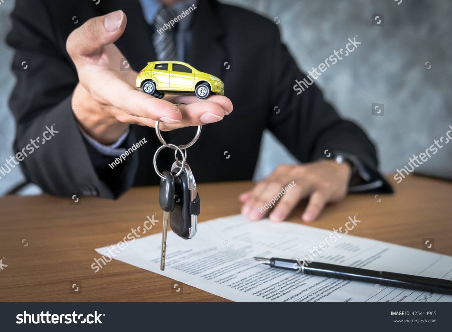 transportation and ownership concept - customer and salesman with car key