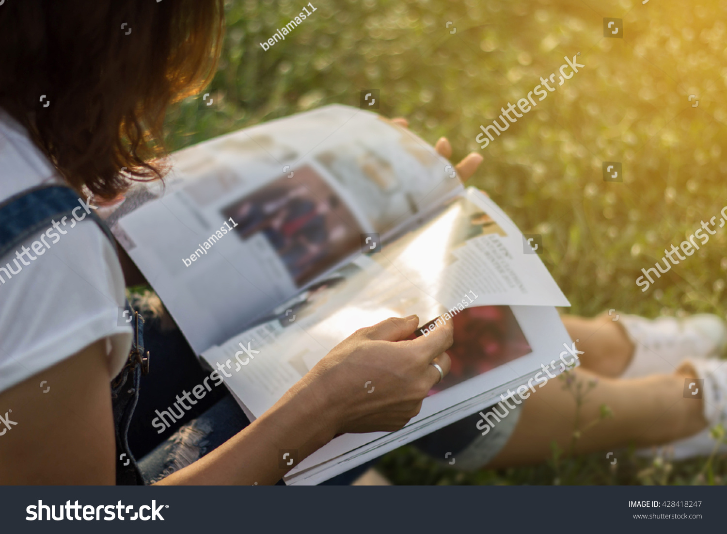 Woman reading a magazine in garden.