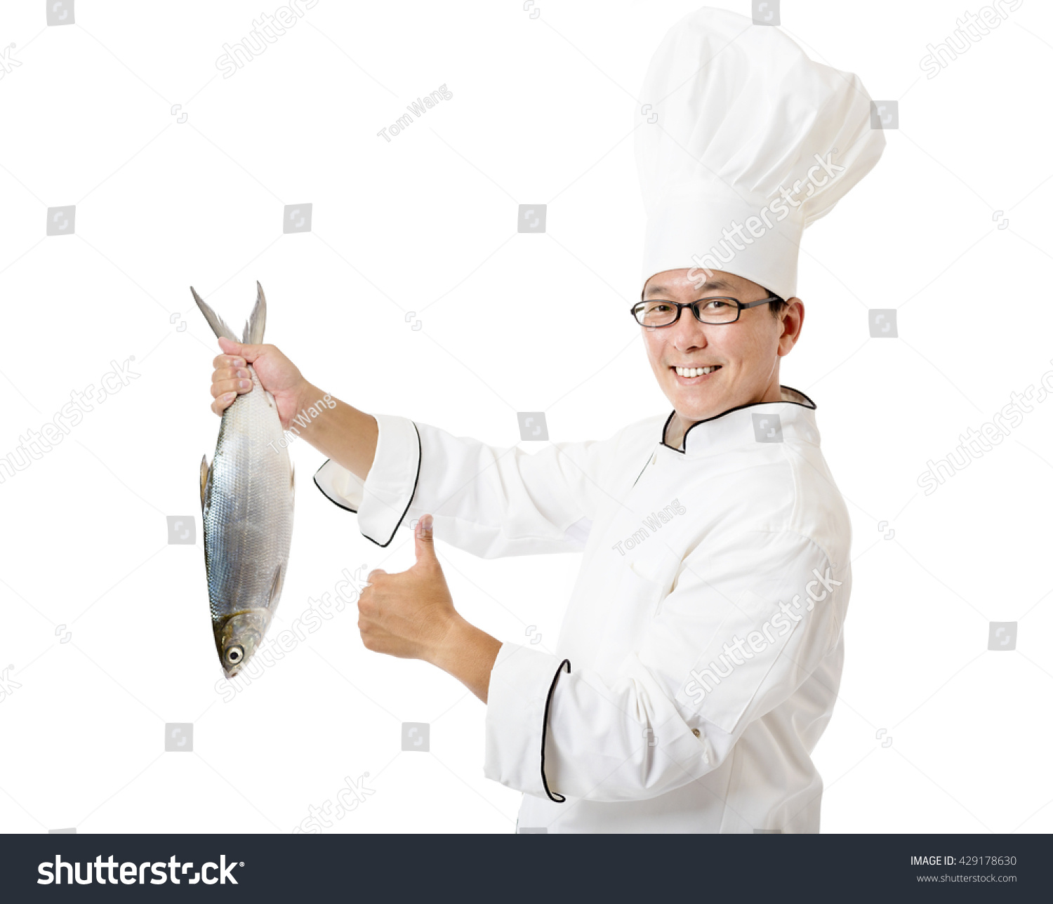 happy chef holding big fish isolated on white