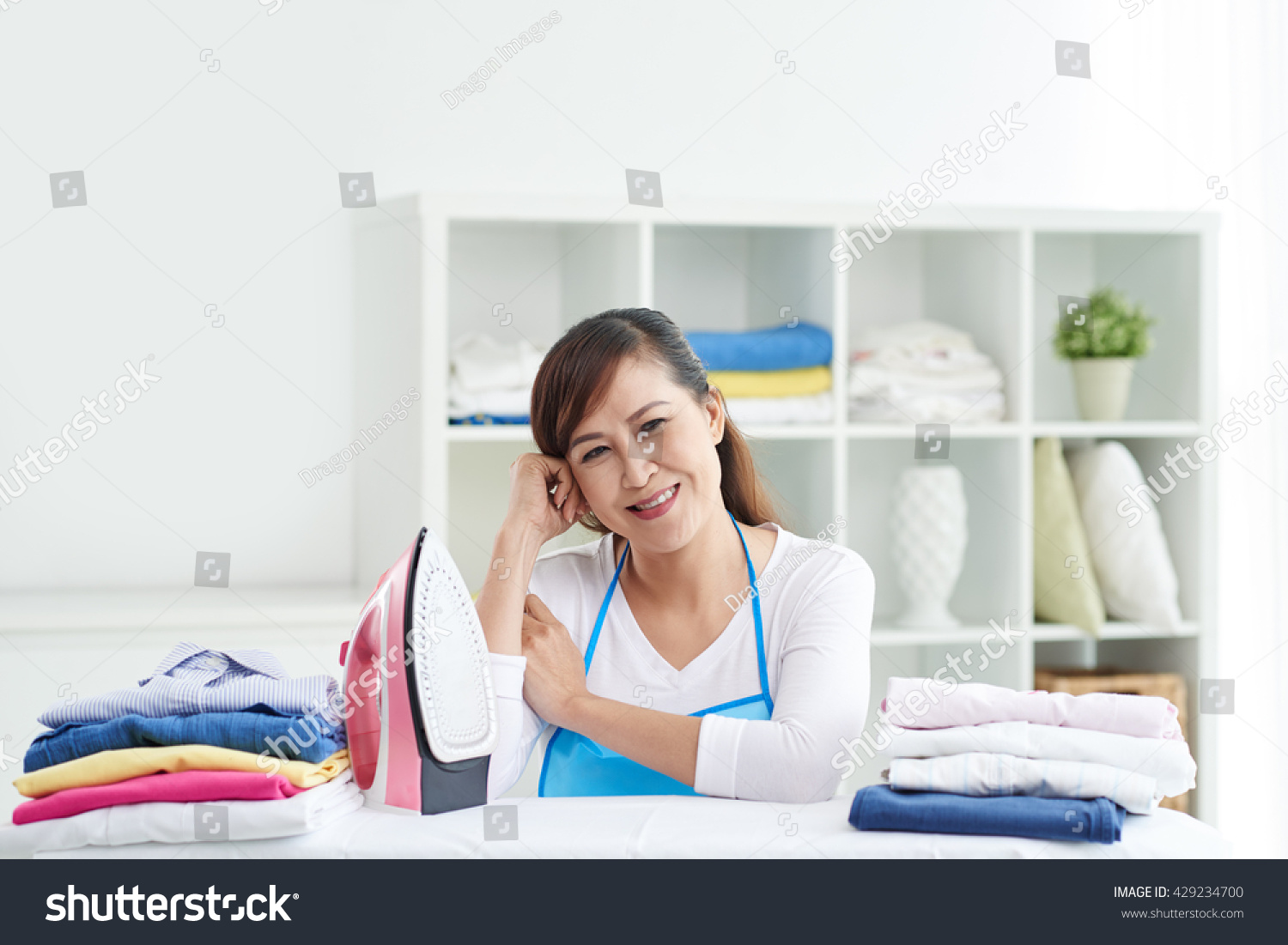Woman ironing clothes after washing
