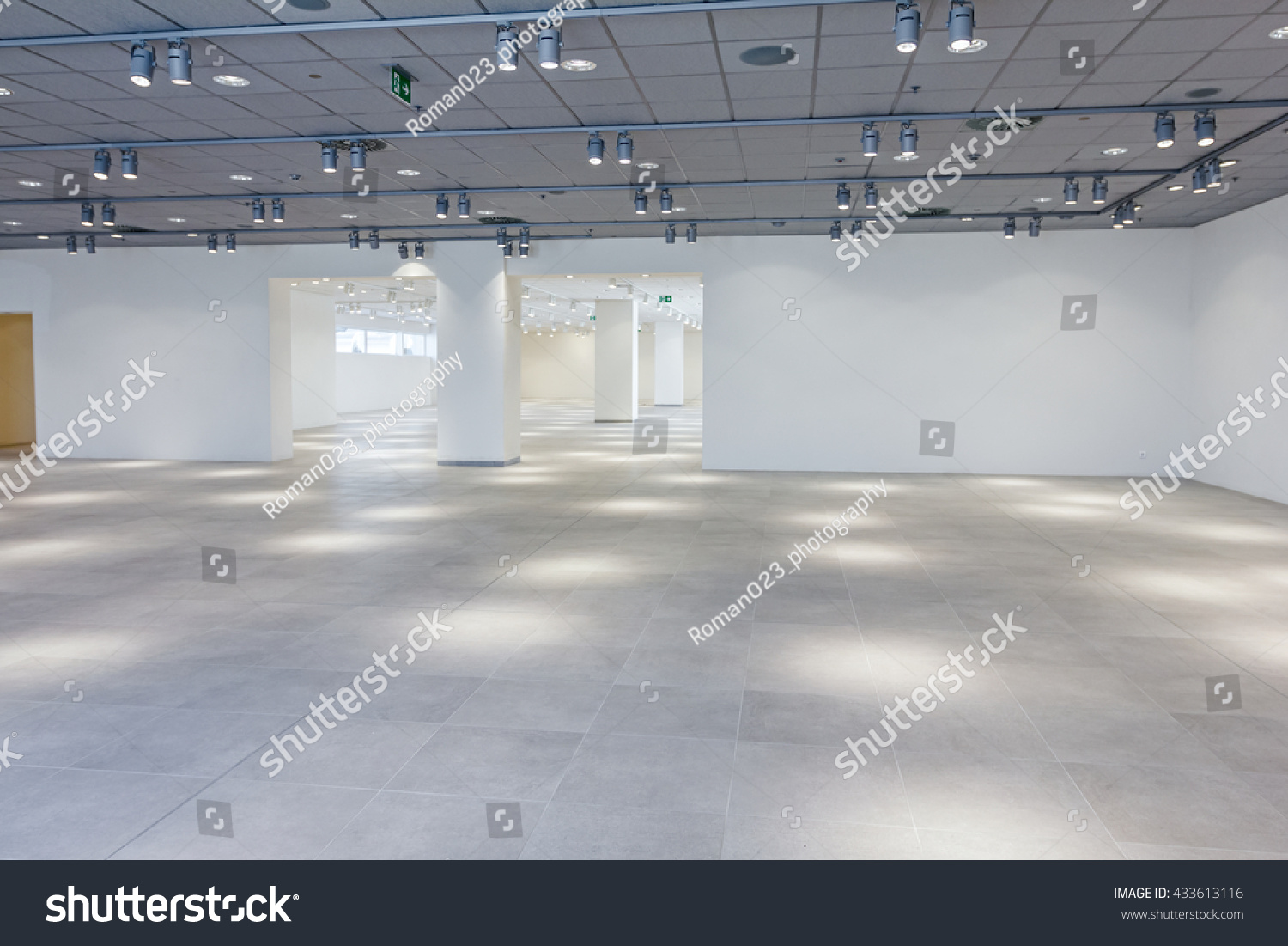 View on large showroom in a modern business centre with ceiling lamps.