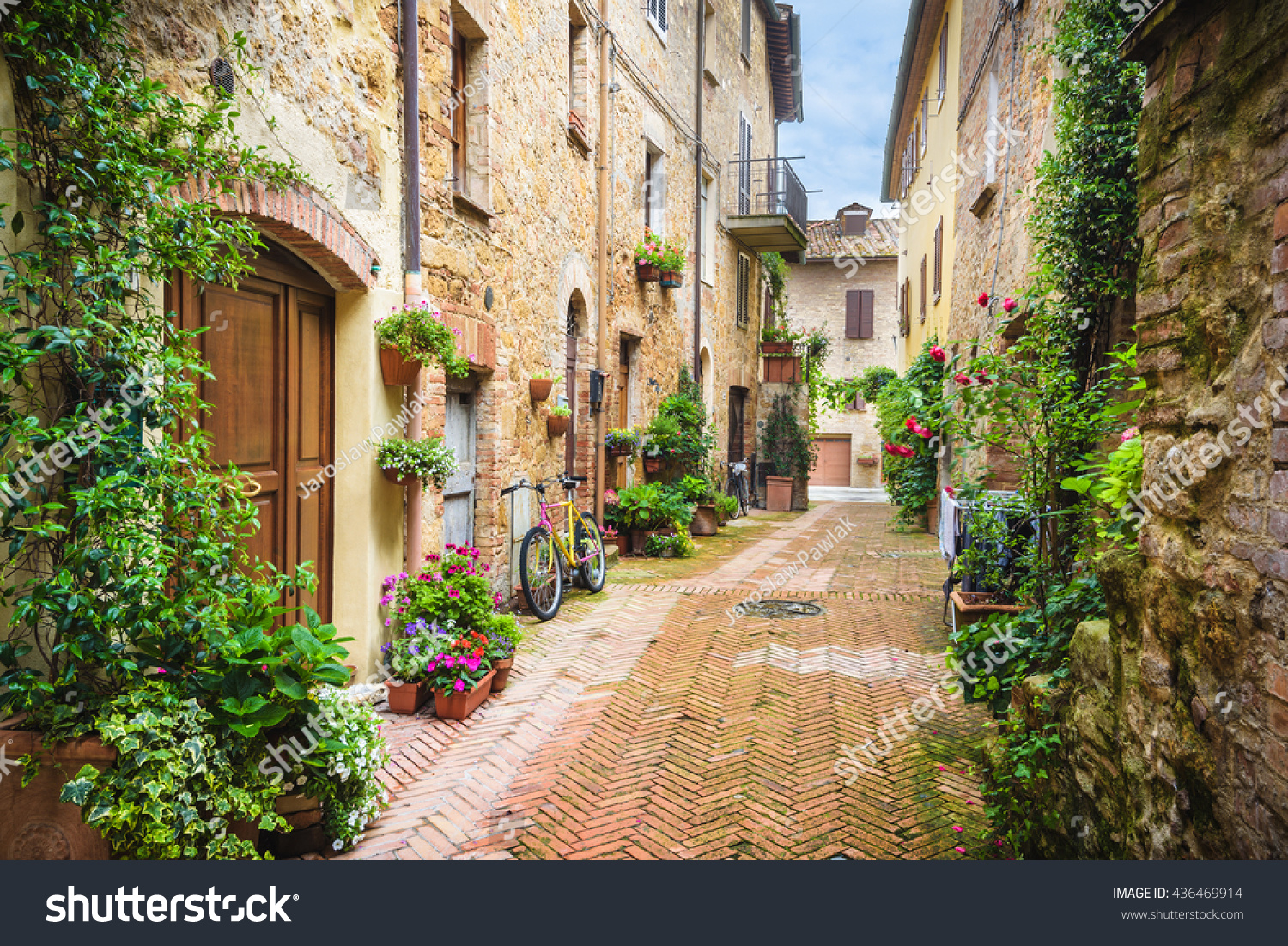 Flowery streets on a rainy spring day in a small magical village Pienza  Tuscany.