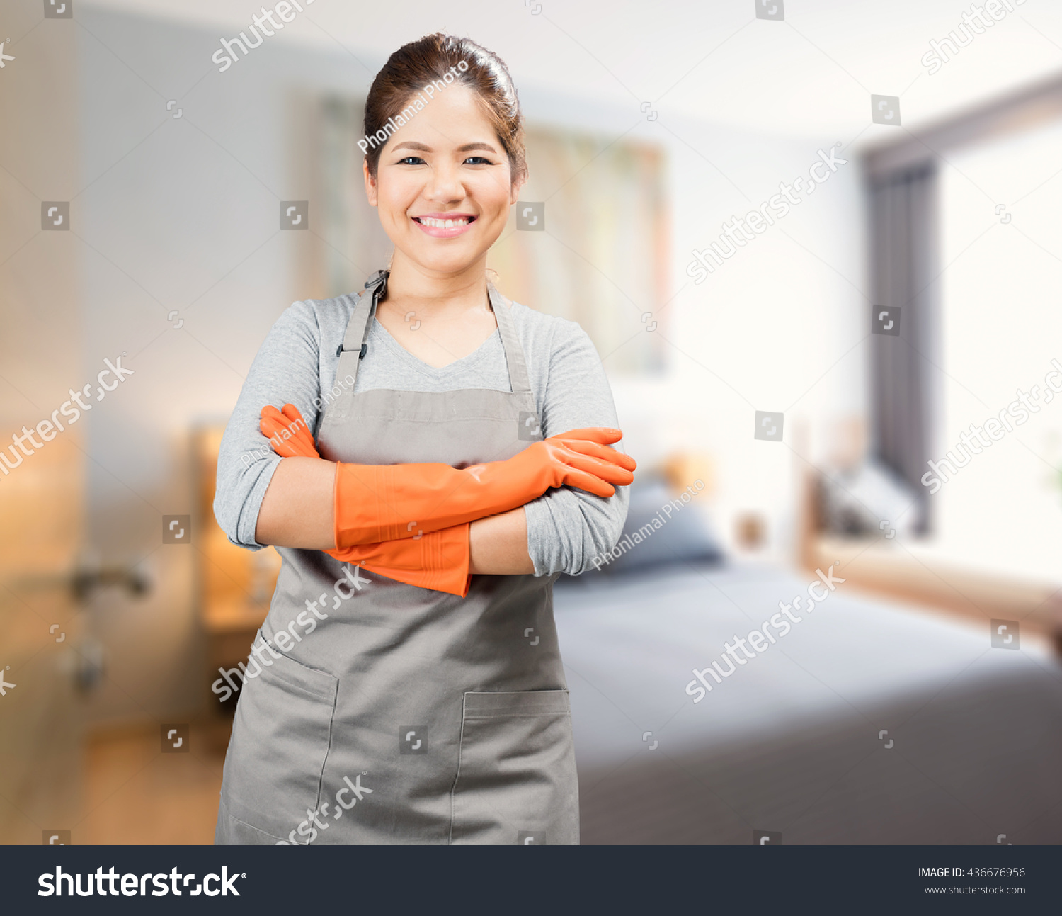asian housewife wearing rubber gloves crossed arms