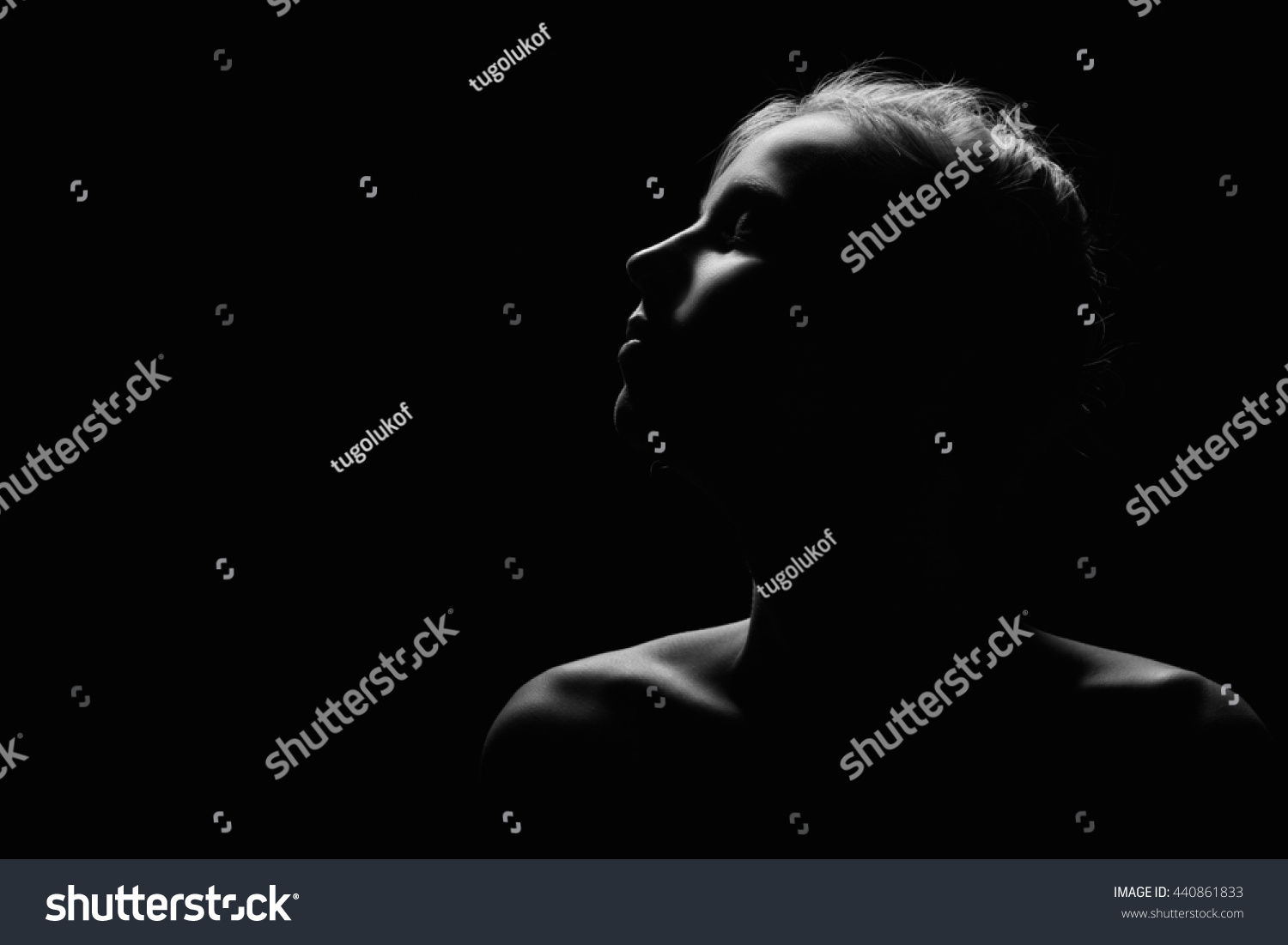 female profile on black background monochrome image with copyspace