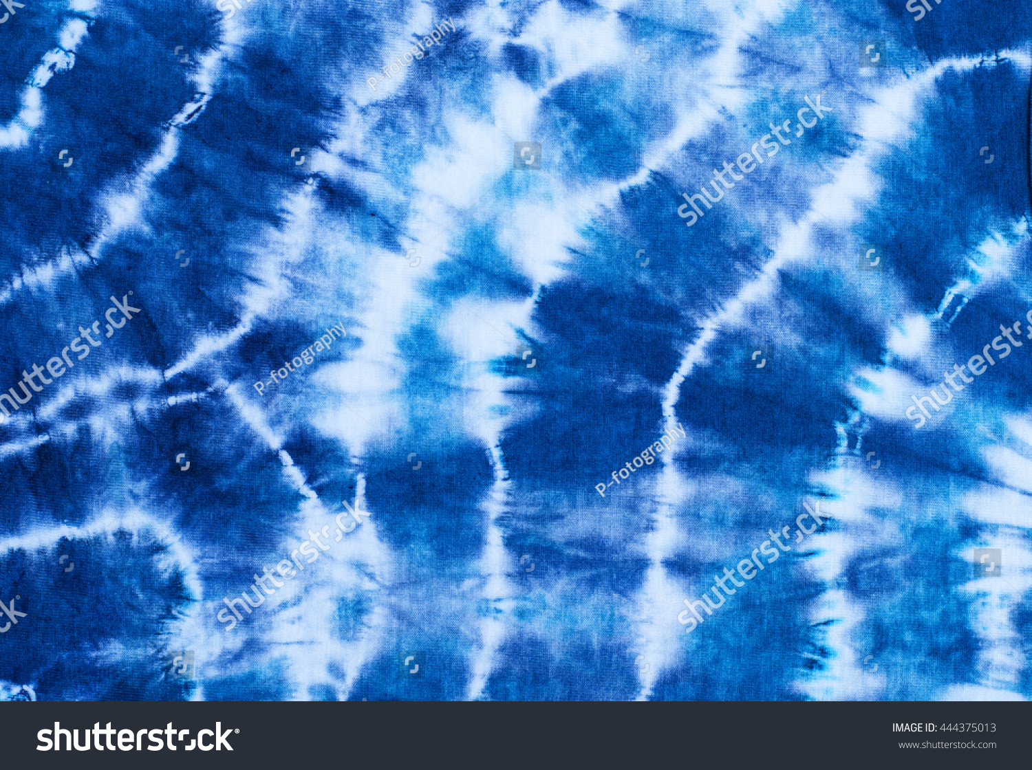 indigo tie dye pattern on cotton fabric abstract background.
