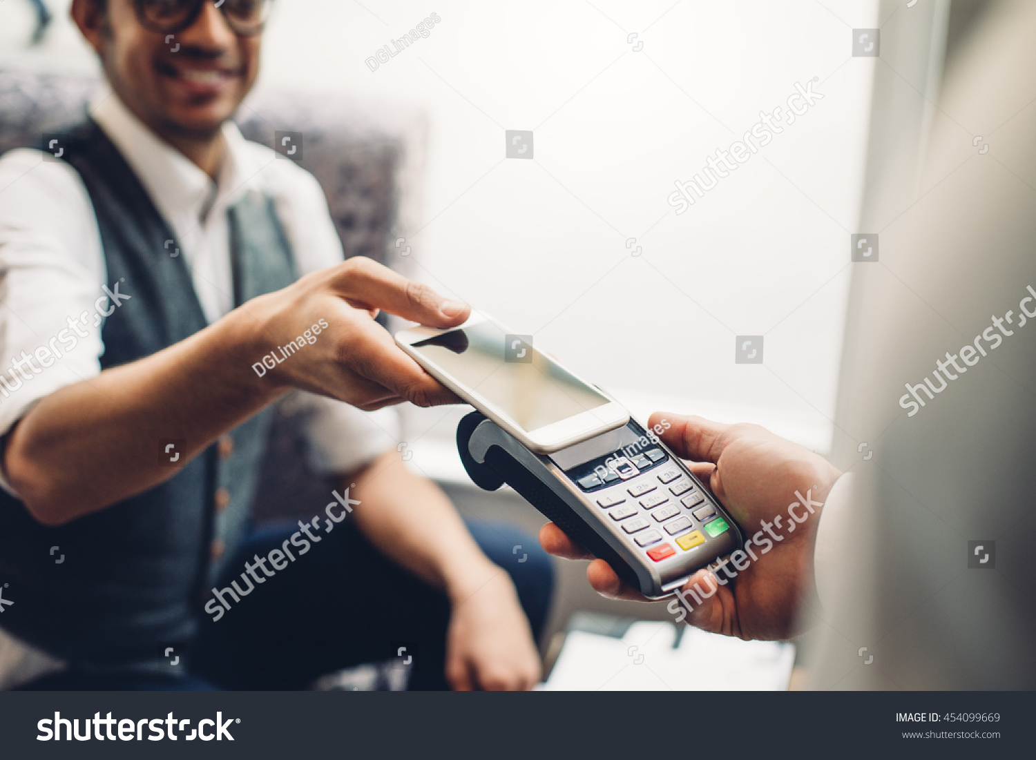 Business man making a contactless smartphone payment.