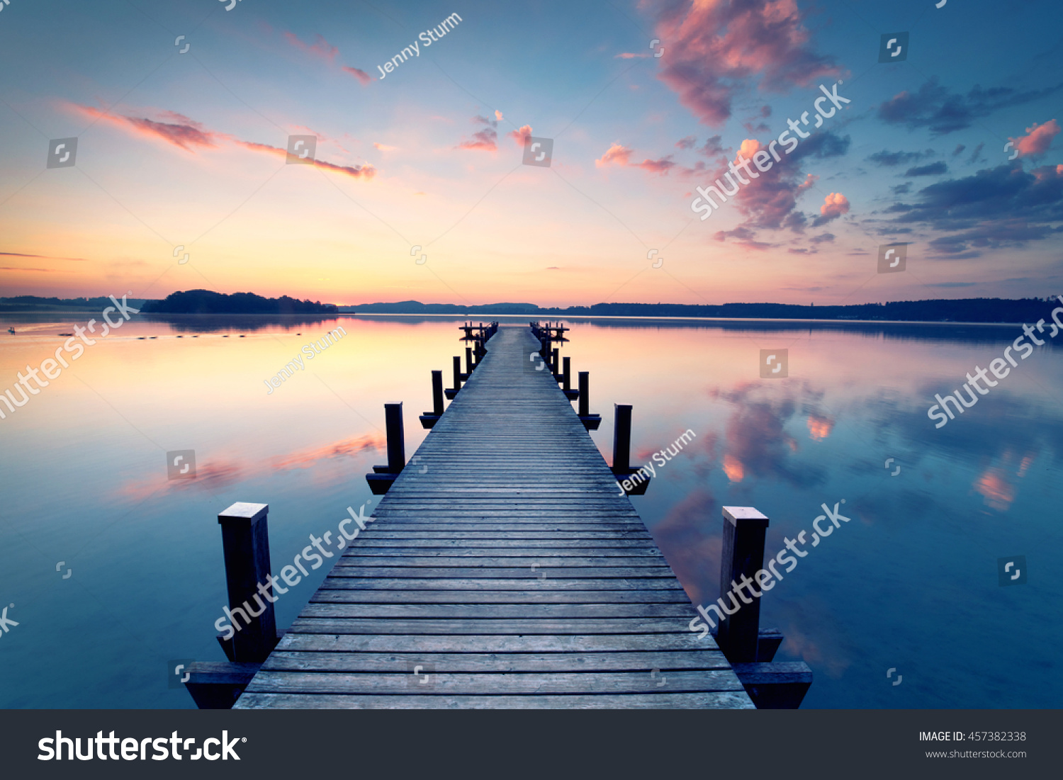 long pier leading out onto the lake  sunrise on lake  long way out                                