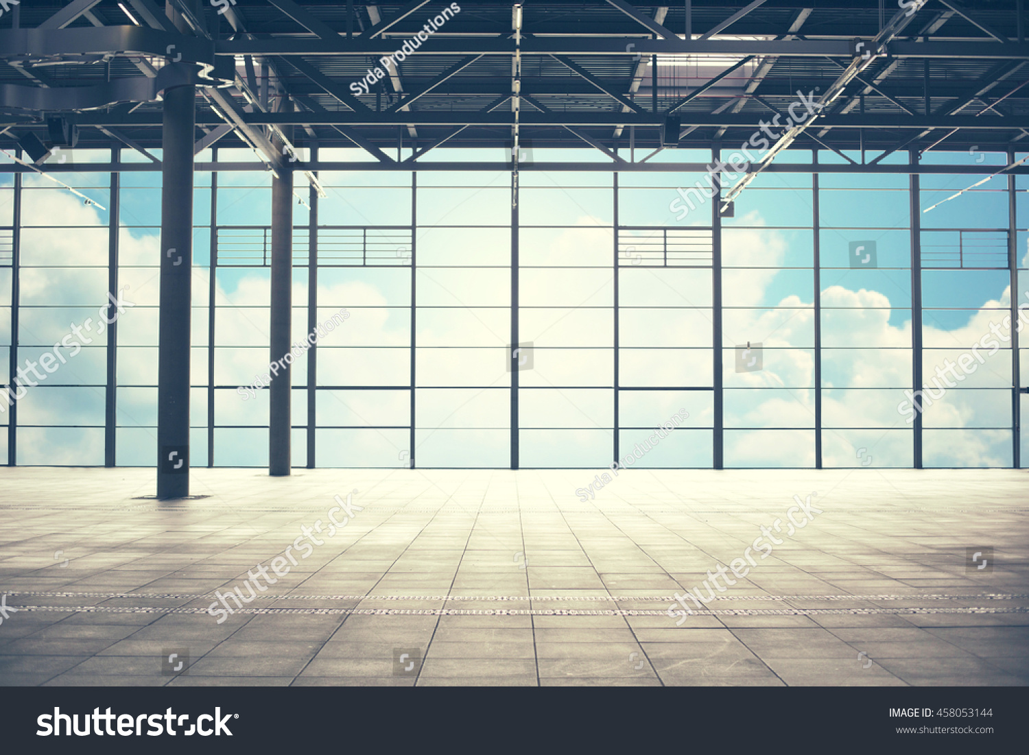 construction architecture and building concept - airport terminal empty room over blue sky and clouds background